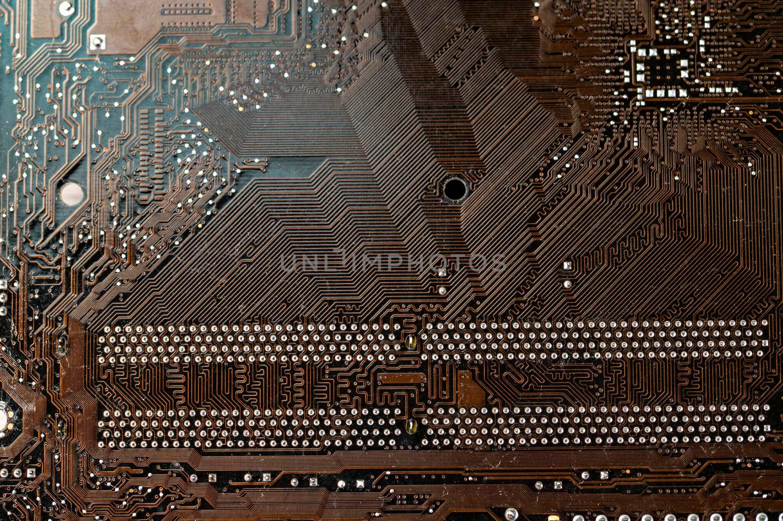 detail of the back of a motherboard with the solder track