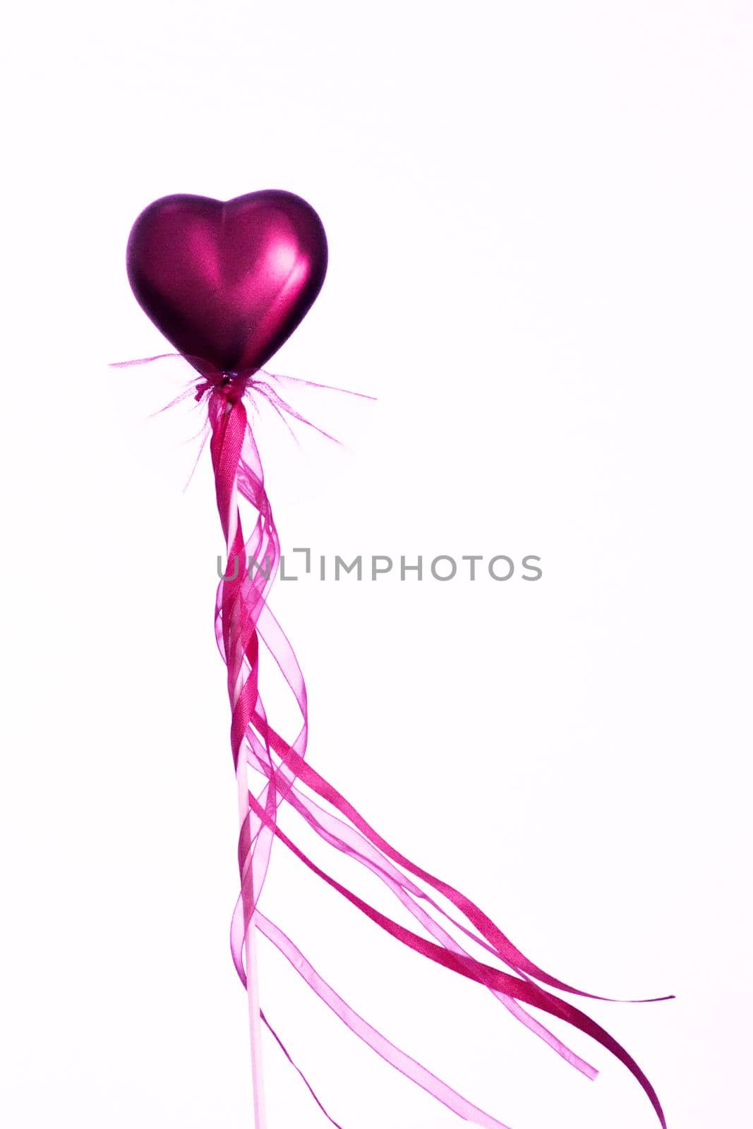 Red heart attached to a stick with a bow hanging by GemaIbarra