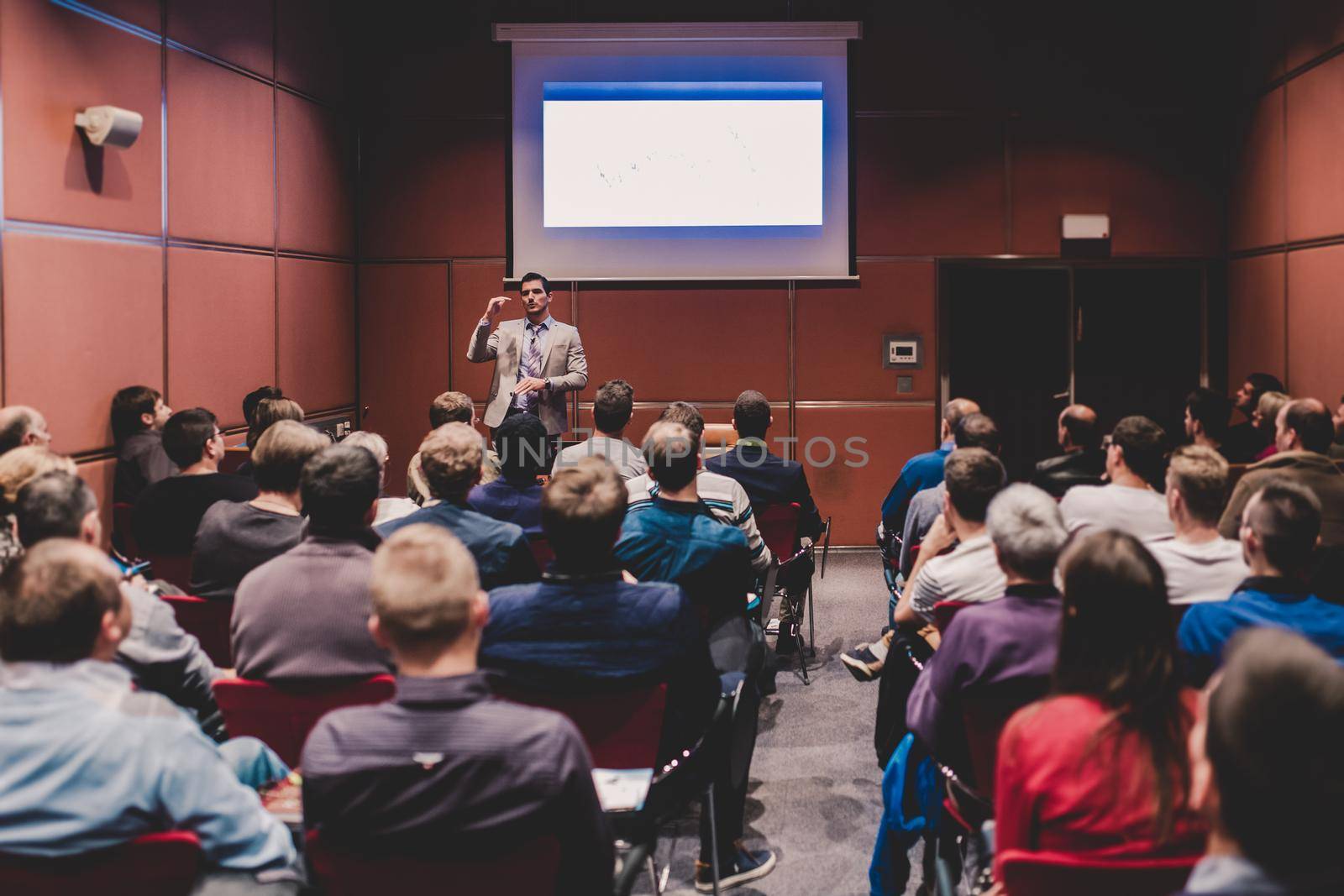 Speaker Giving a Talk at Business Meeting. Audience in the conference hall. Business and Entrepreneurship concept.