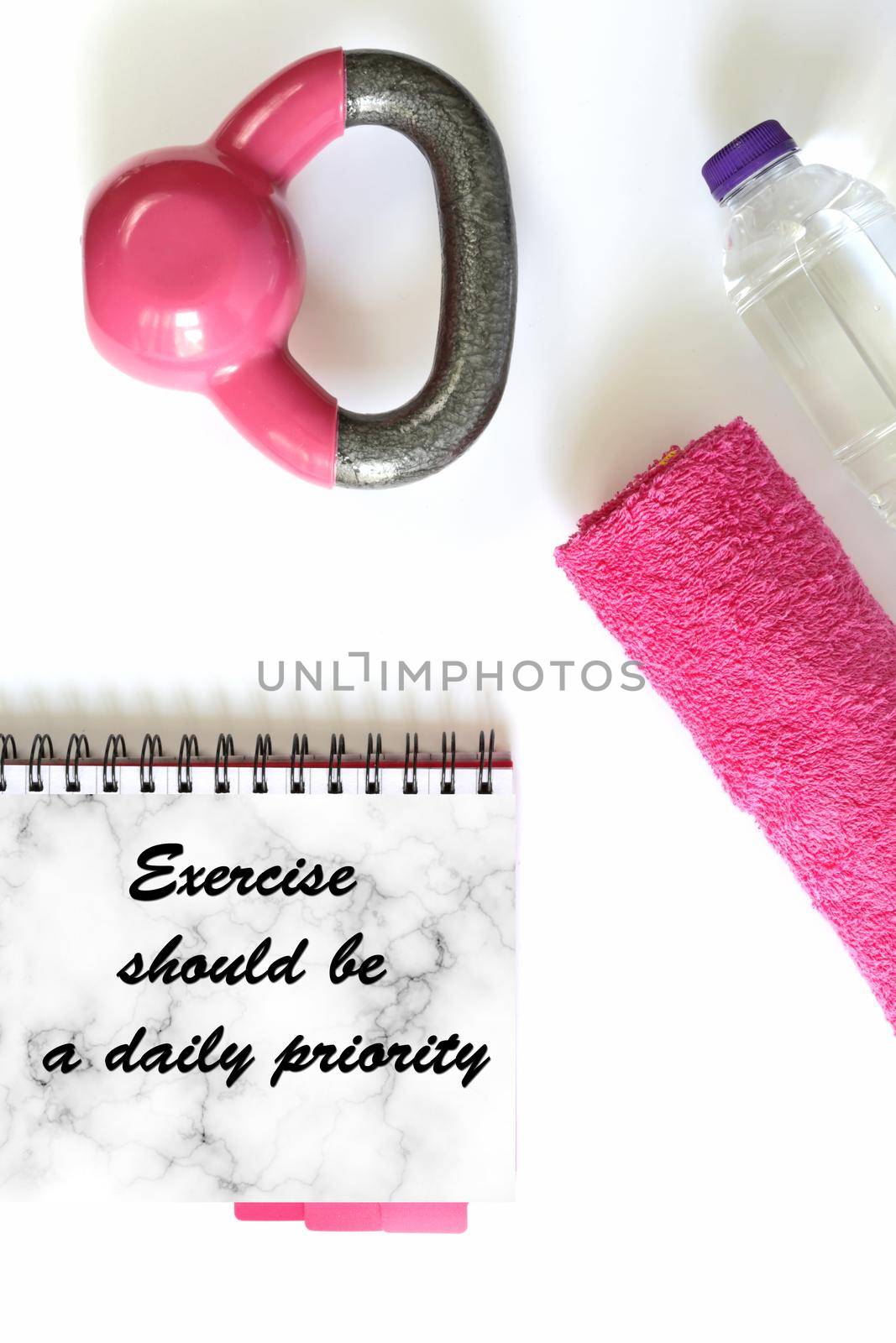 Fitness motivational quote. Healthy lifestyle, fitness, sport, athlete's equipment in pink colour on white background. Quote text Exercise should be a daily priority. Copy space, mock up