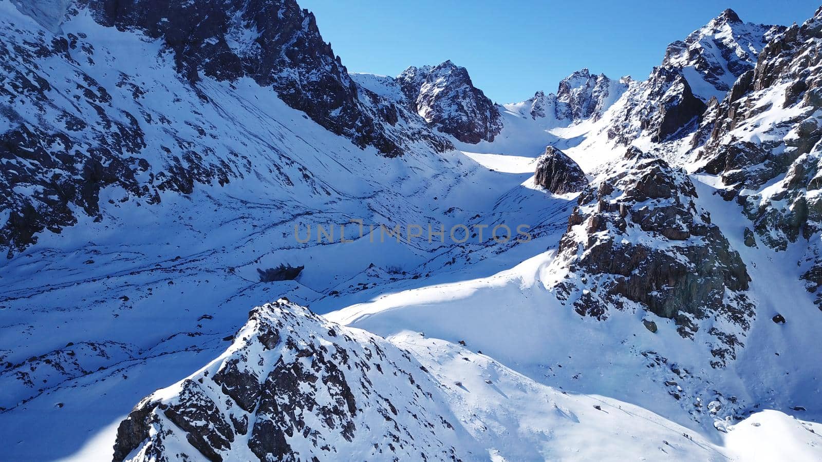 A group of climbers is walking in the mountains. by Passcal