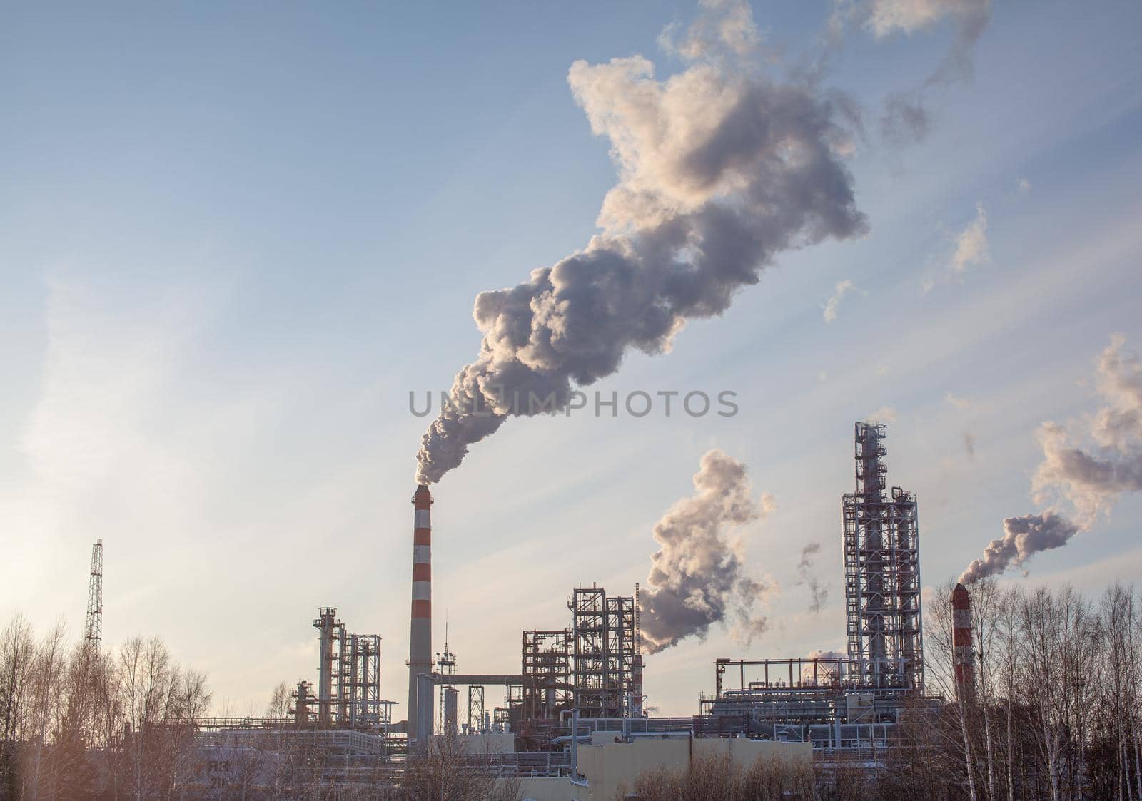 Petrochemical industrial factory of heavy industry, power refinery production with smoke pollution. Thick smoke is coming from the factory's chimney