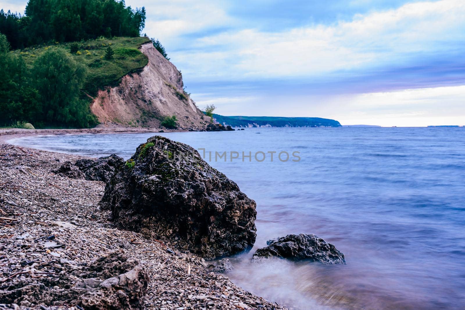 stone on the riverbank and cliff with woodland on background by Seva_blsv