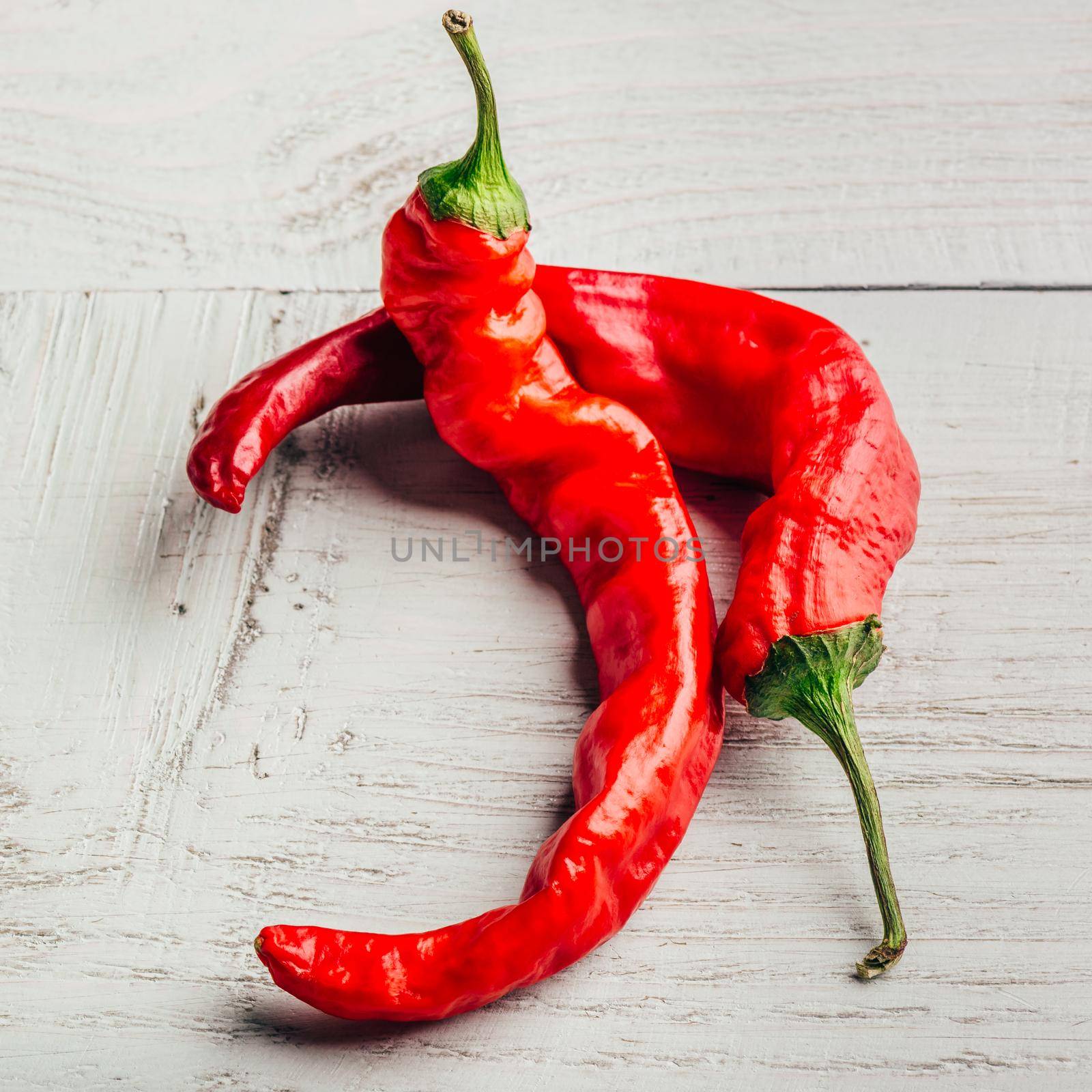 Red chili peppers on wooden background. by Seva_blsv