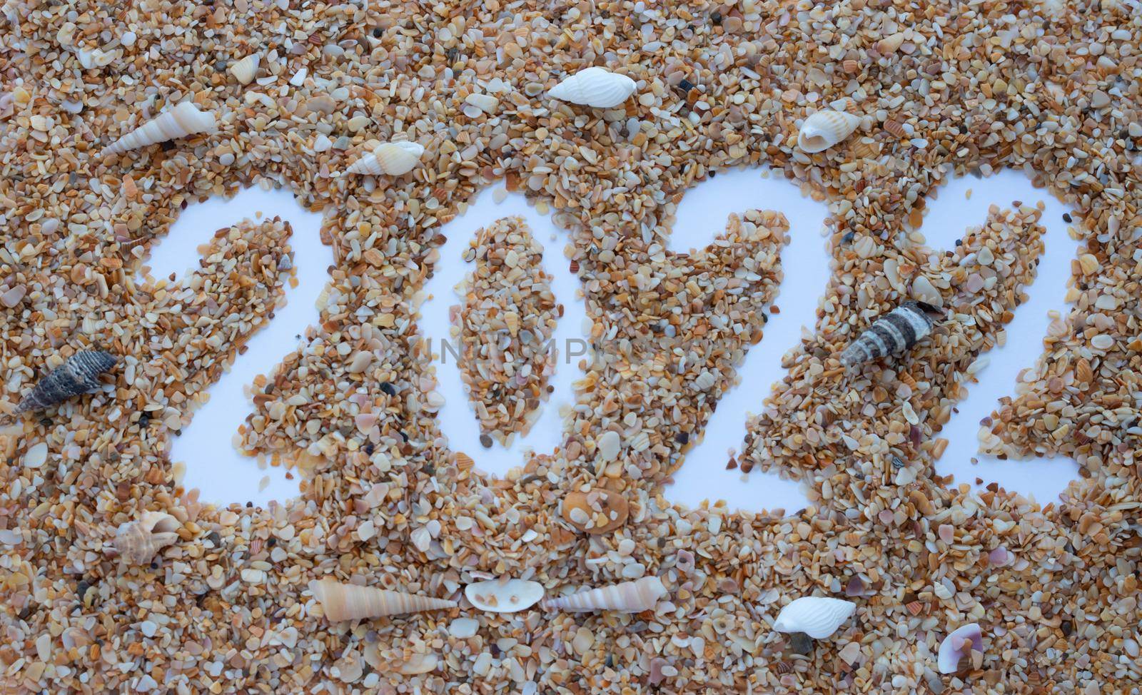 The number 2022 is drawn on the sand of shells.New Year's Calendar.