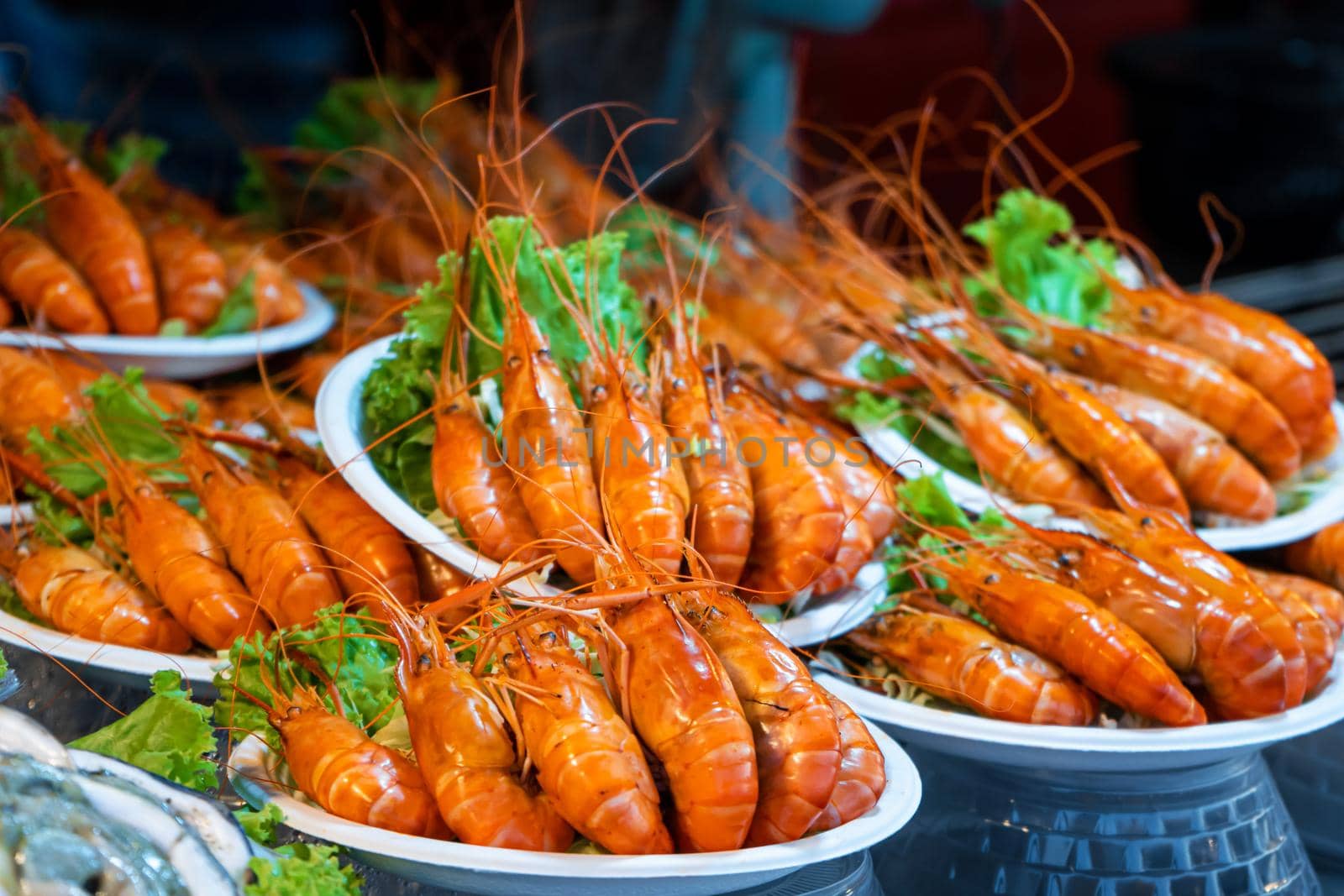 Plates of huge boiled shrimp at the street food market.