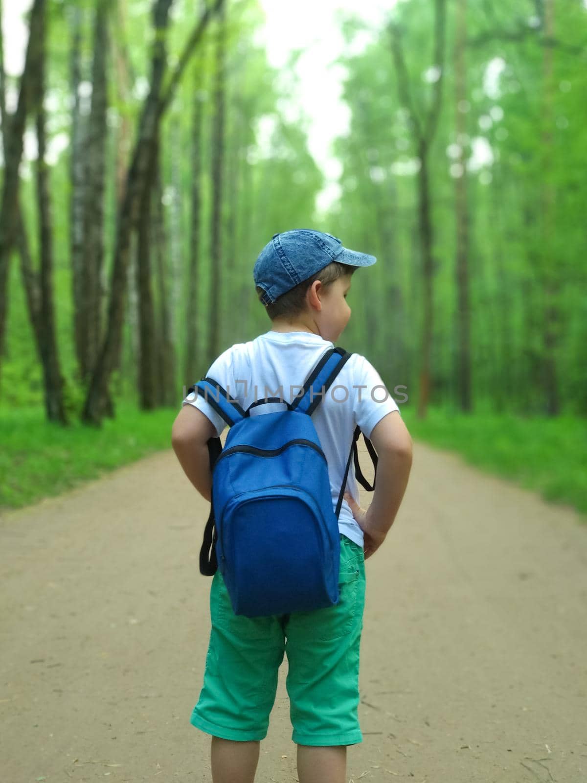 The boy is traveling with a backpack on his back.  by Alina_Lebed