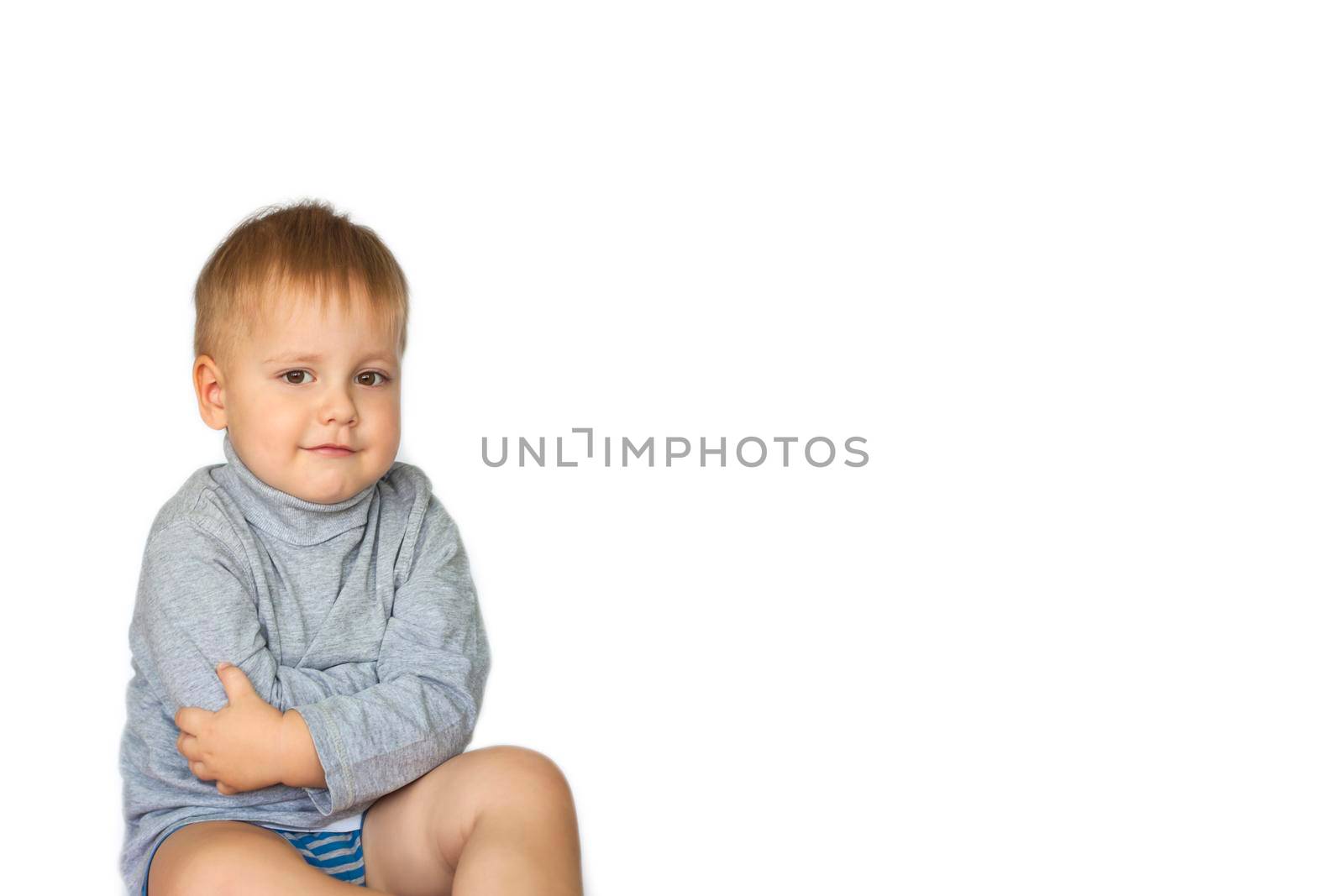 Portrait of a cute, funny boy. The boy poses on a white background. The expression on his face. Portrait