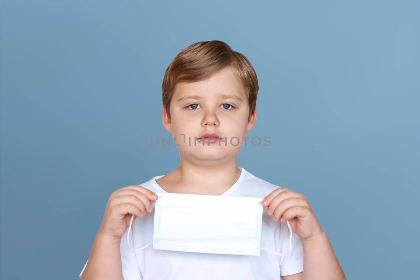 A boy in a medical mask. Coronavirus, disease, infection, quarantine, medical mask, COVID-19. Quarantine and protection from influenza viruses and epidemics covid-19. Coronavirus quarantine. 