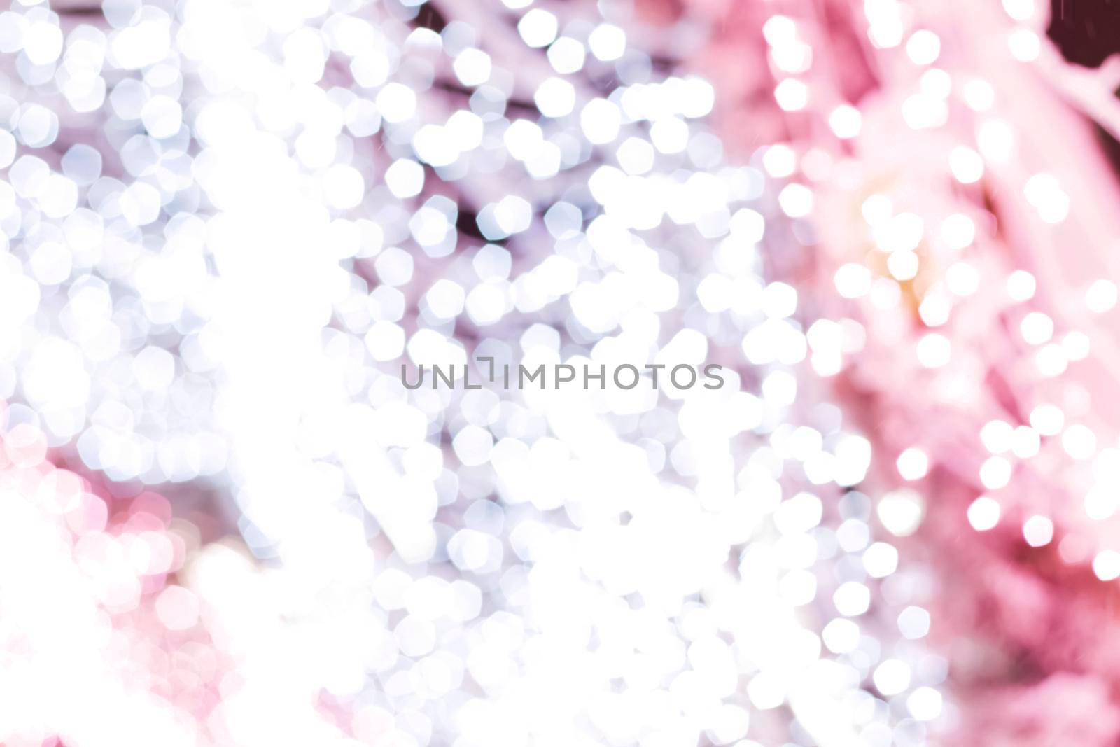 Blurry Christmas lights. Beautiful bokeh. Christmas and new year. Background for a greeting card or advertising banner. The glare of the lights. 