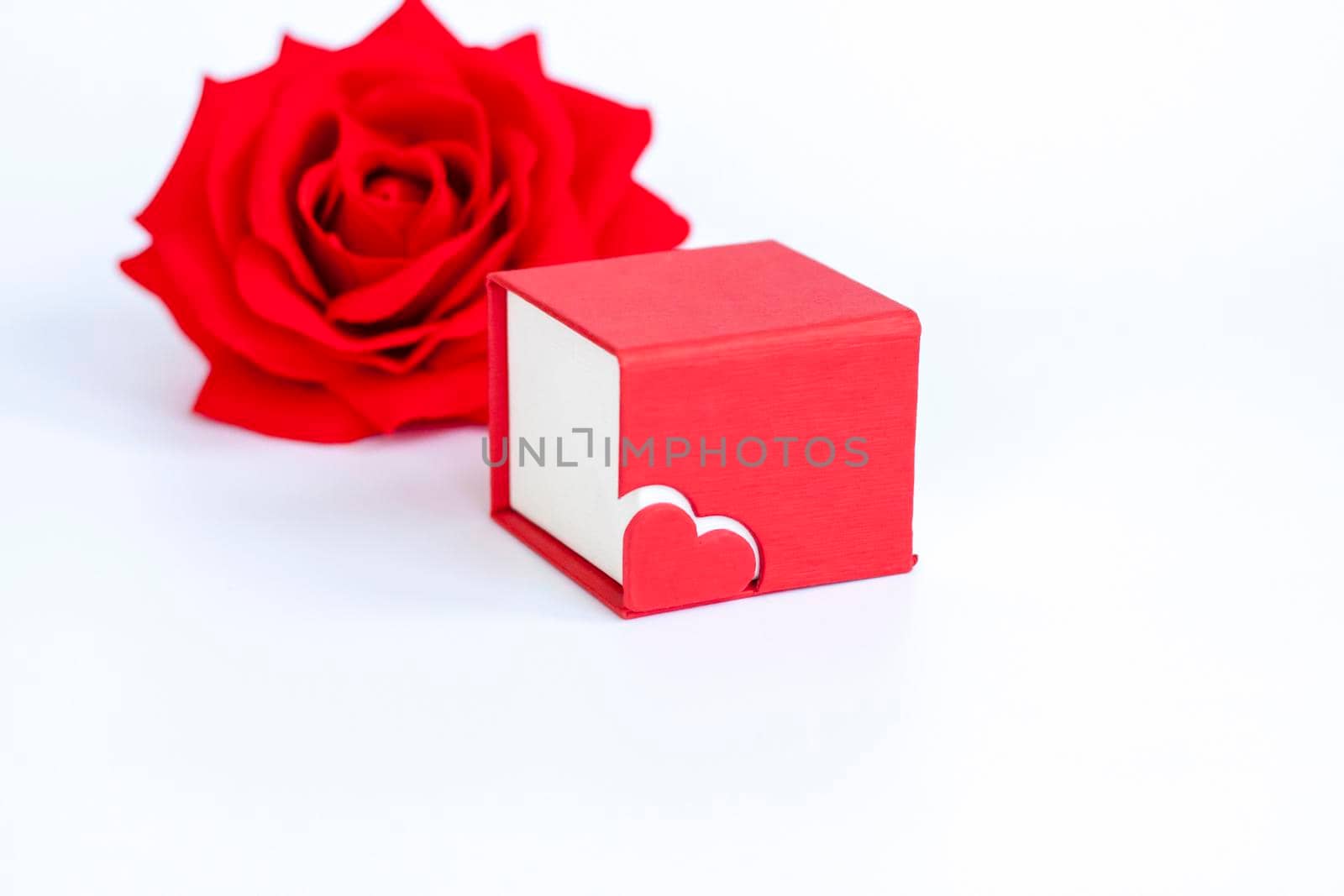 Red box for decoration with a heart and a rose on a white background. Make a Declaration of love. The concept of the Valentine's Day theme. Isolate.