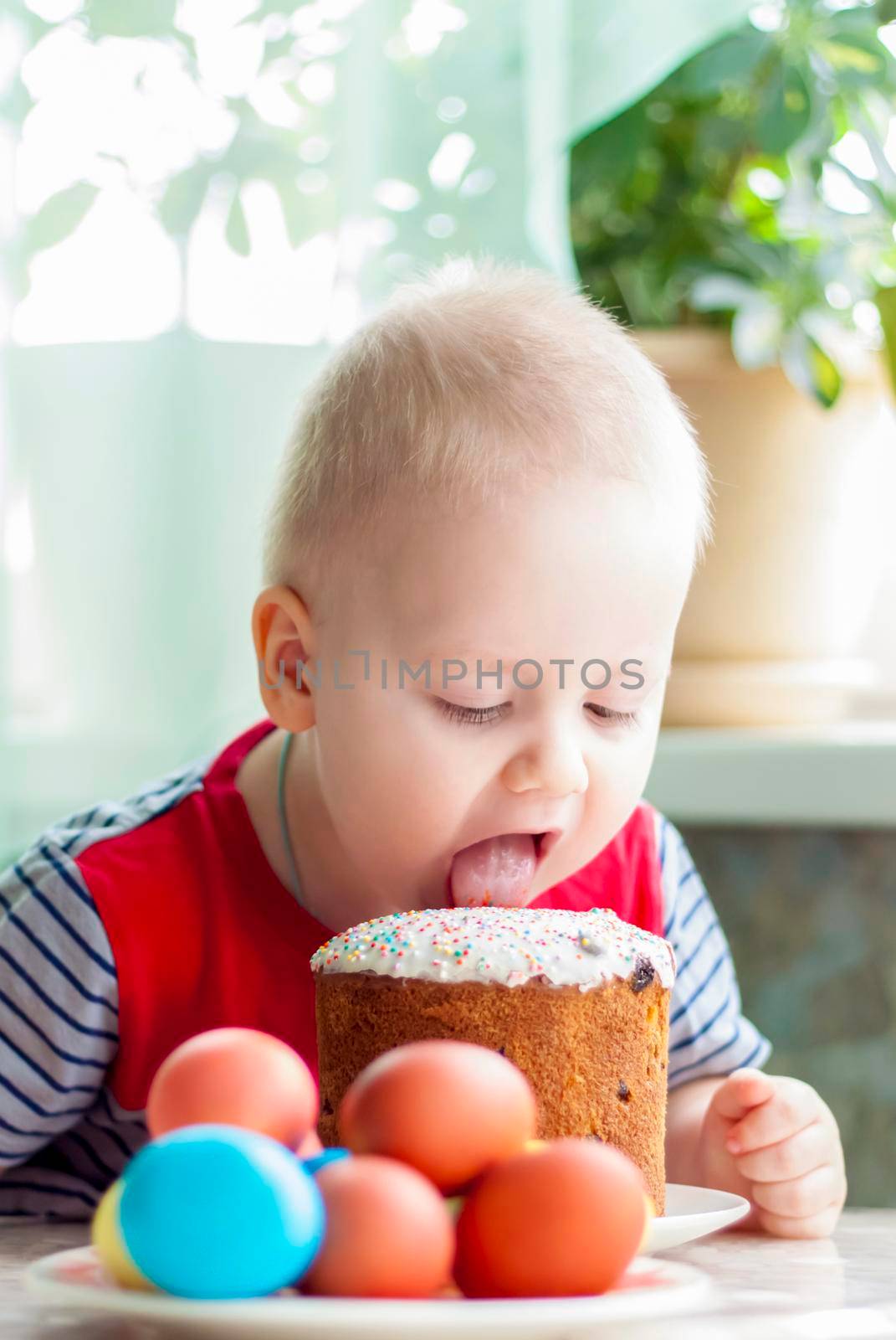 Portrait of a cute child with Easter eggs. Easter lunch. The feast of Holy Easter. Painted Easter eggs.