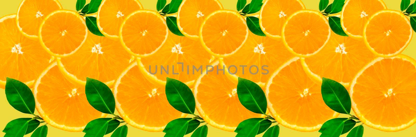 Sliced orange on a bright orange background. Oranges in the panoramic image. Panorama, a banner with space for text or insertion. Pieces of citrus fruit. Template for creative and graphic works