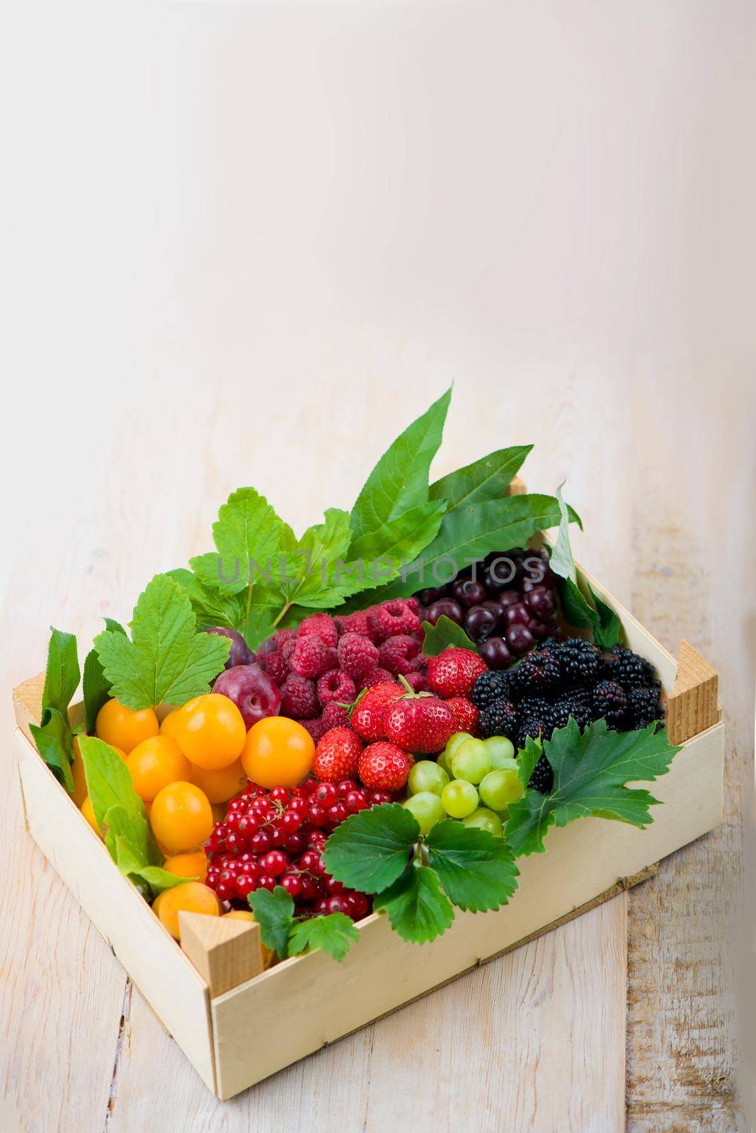 berry mix isolated in the box on a white background by aprilphoto