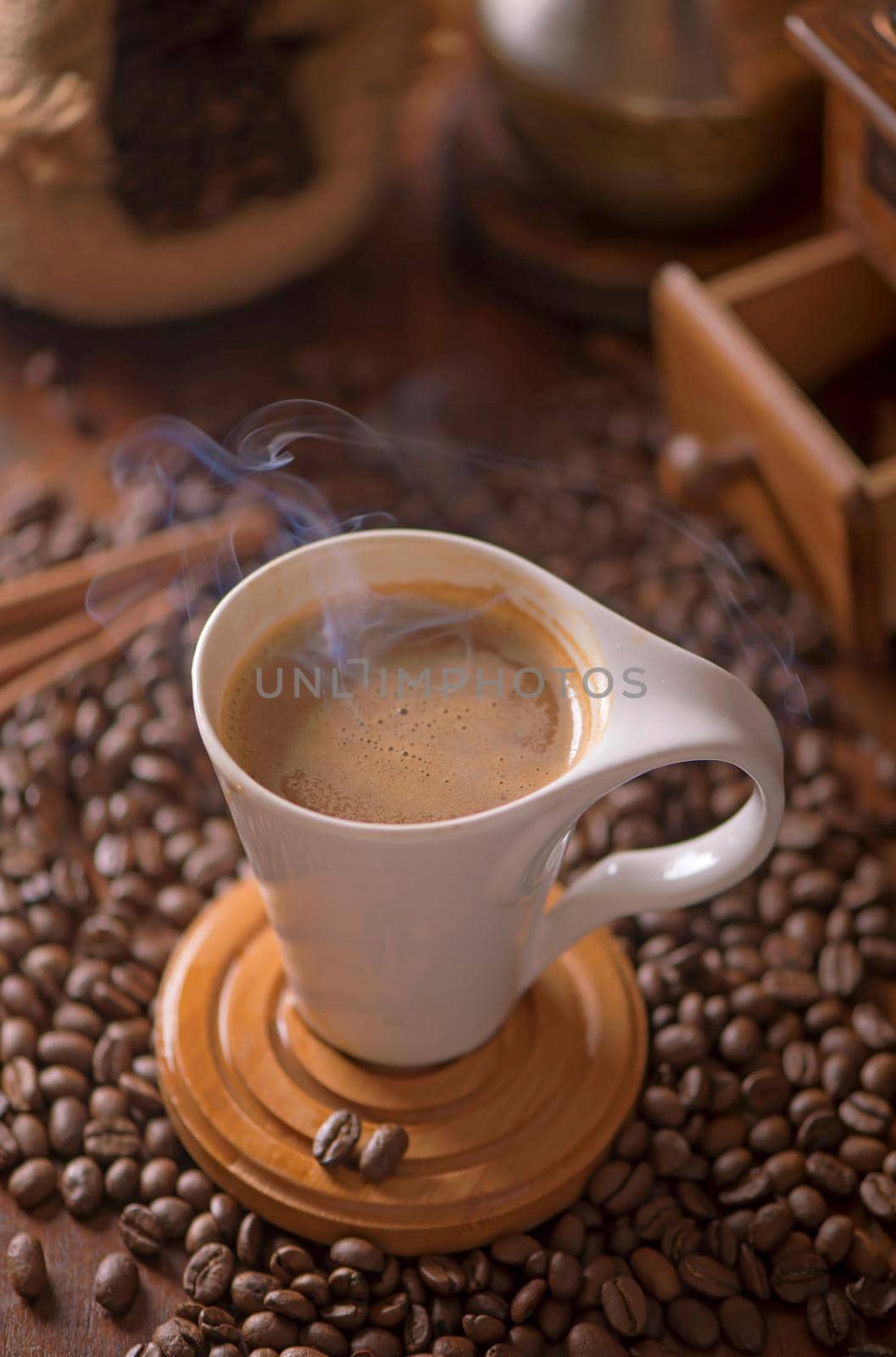 cup of coffee and coffee beans in a sack on dark background, top view by aprilphoto