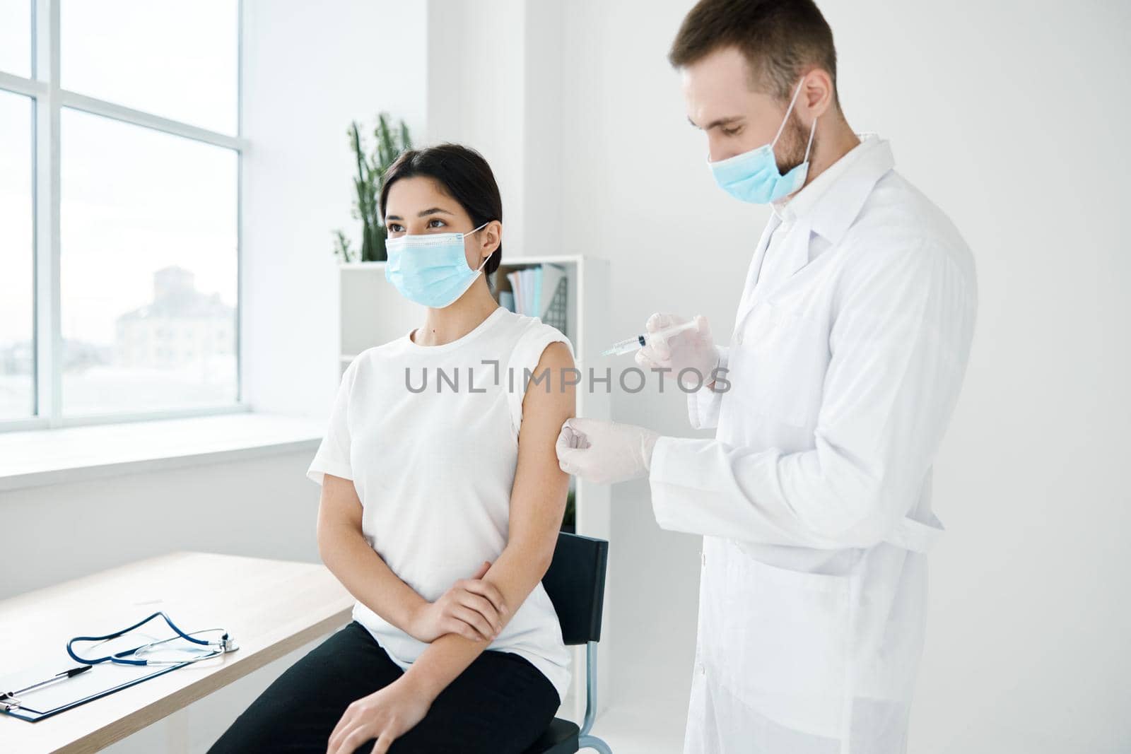 doctor and patient wearing medical masks covid-19 injection vaccination infection epidemic by SHOTPRIME