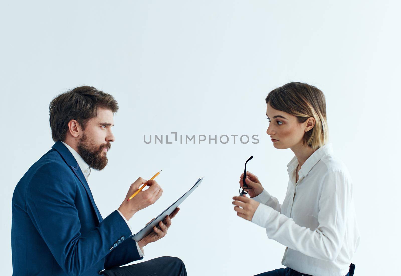 Emotional woman and young man communication on a light background psychology understanding by SHOTPRIME