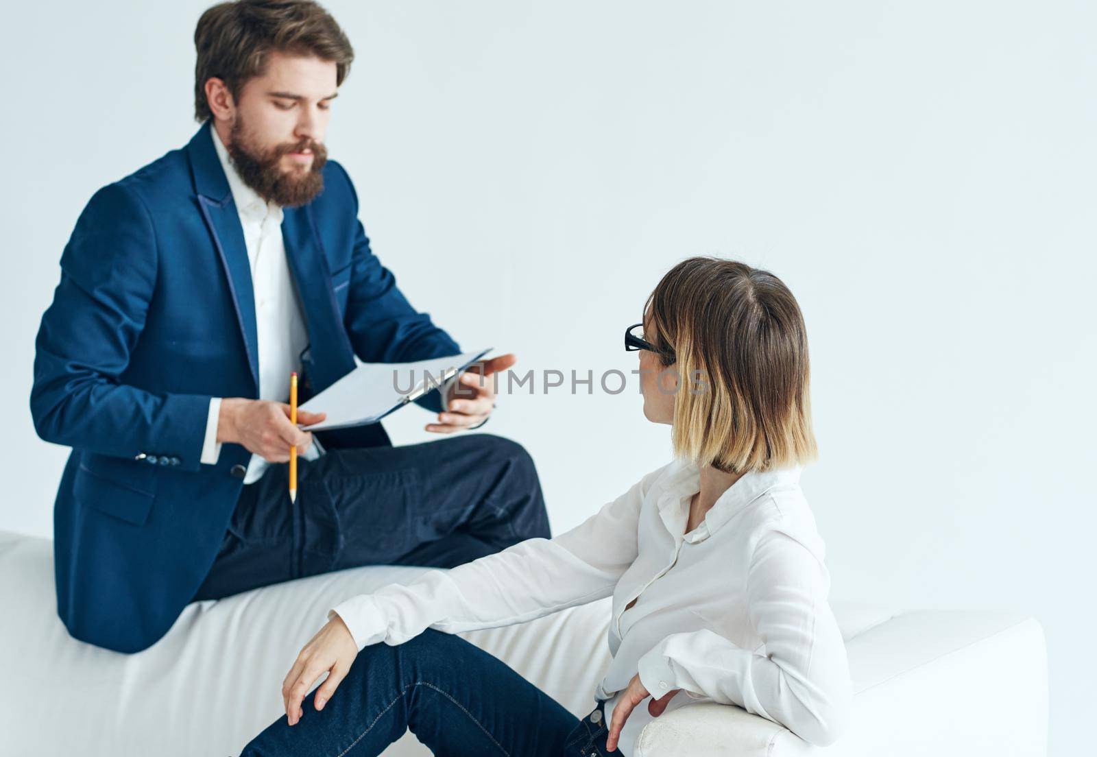 man in suit next to woman businessmen team communicating emotions. High quality photo