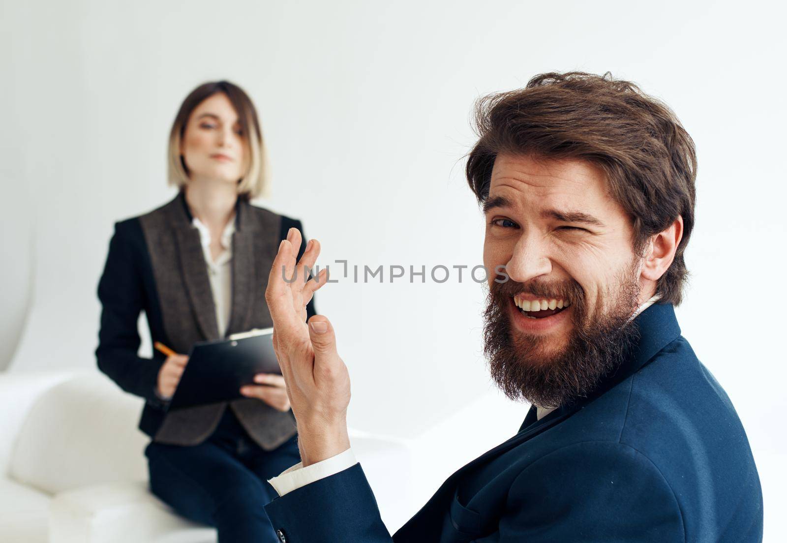 and emotional man at job interview and business woman in suit in the background. High quality photo