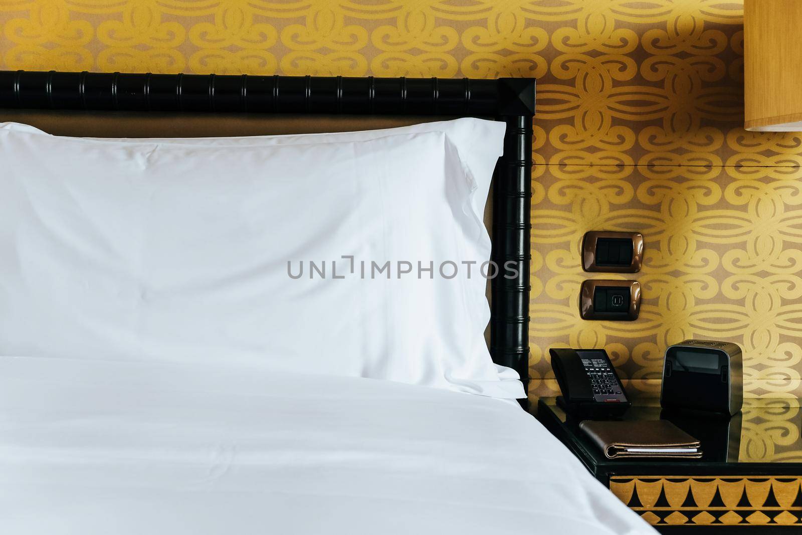 Image of Luxurious bedroom detail, furniture, lamp and accessories.