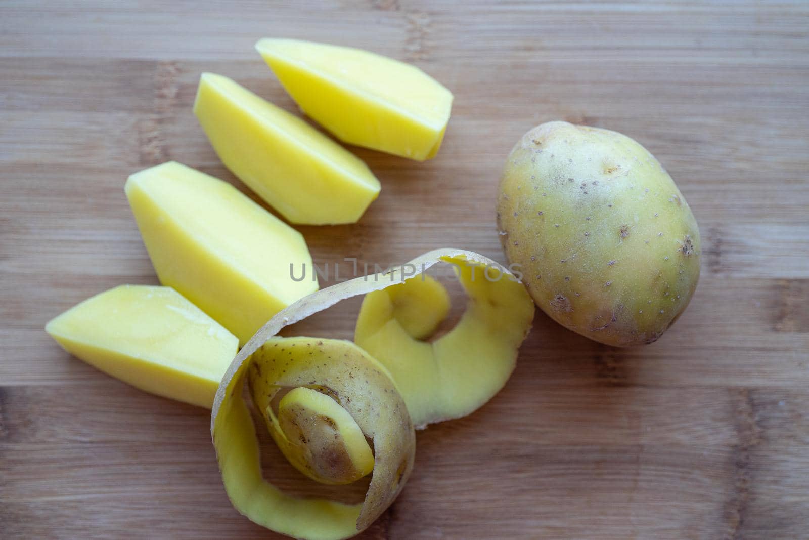 Raw potatoes with peel on a cutting Board