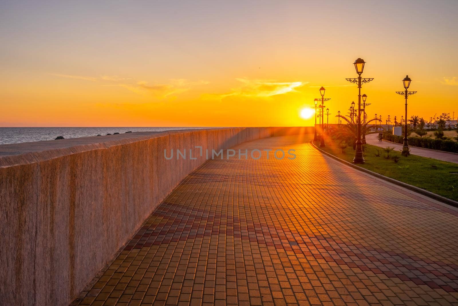 Sunset over the promenade of the resort town. Sochi, Russia