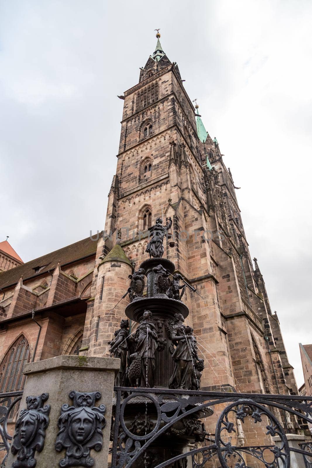 Tugendbrunnen in front of St. Lorenz church (in german Lorenzkirche) in Nuremberg, Bavaria, Germany  in autunm