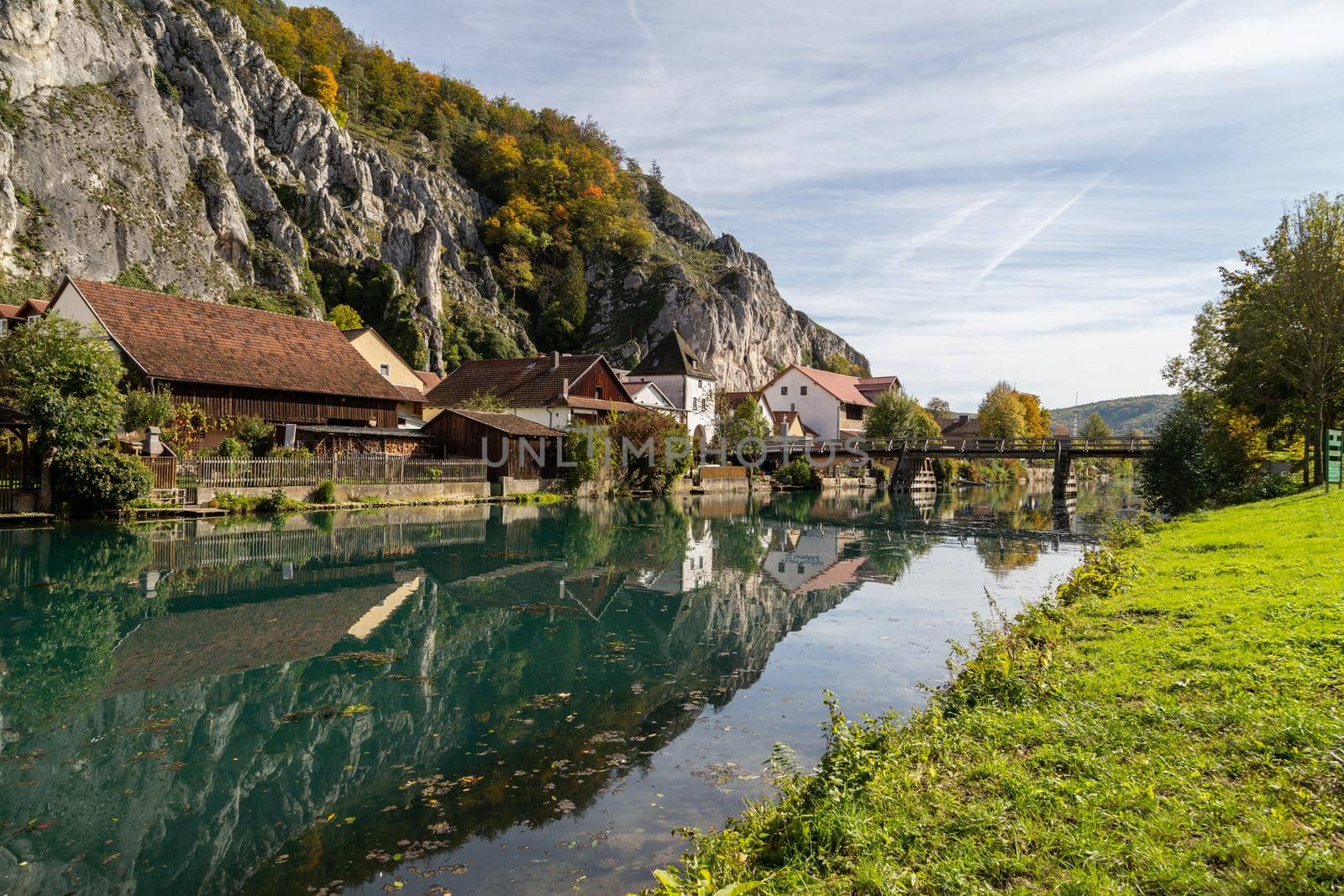 Idyllic view at the village Markt Essing in Bavaria, Germany with the Altmuehl river and high rocks  by reinerc