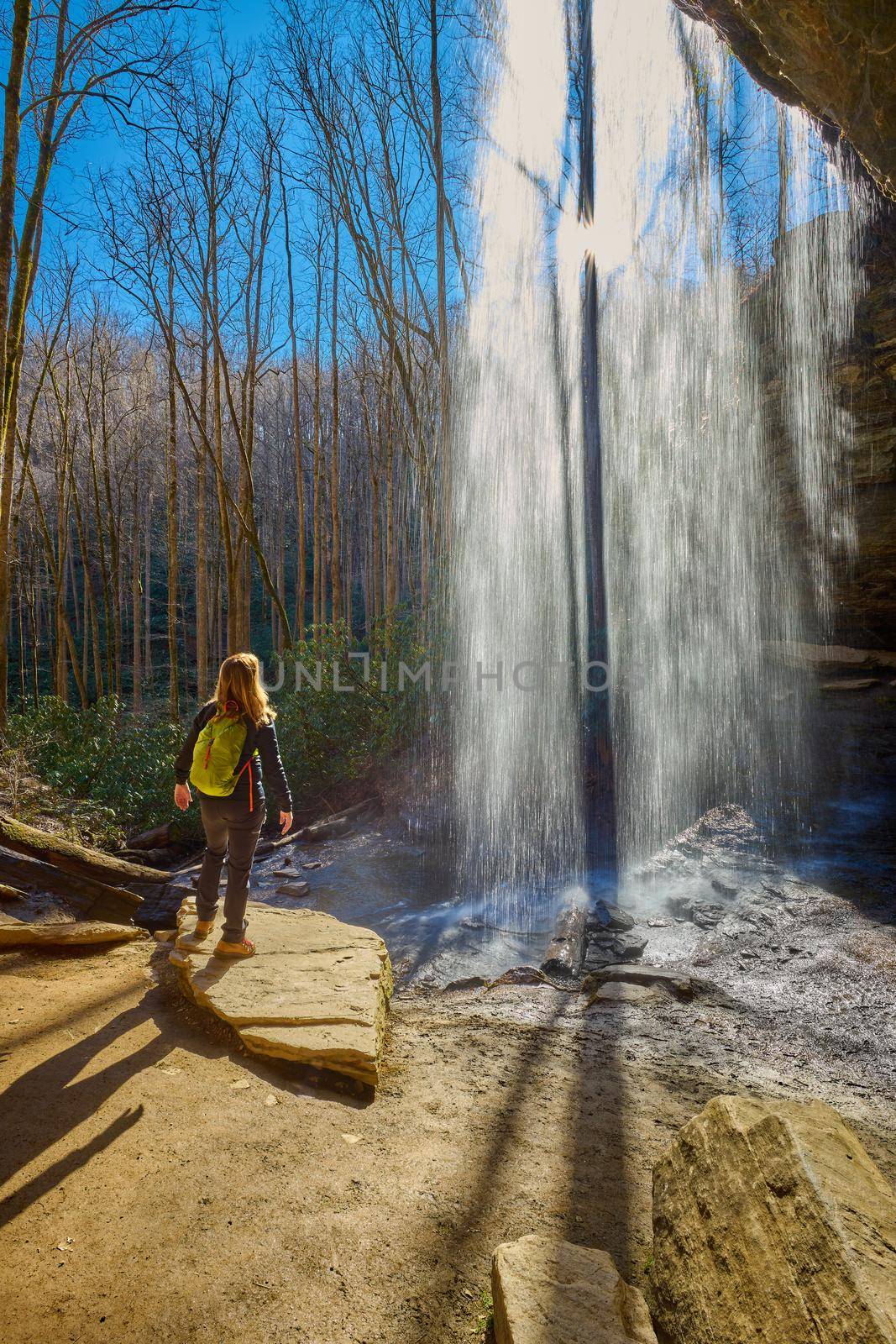 Woman standing near Moore Cove Waterfall in Pisgah National Forest near Brevard NC. by patrickstock