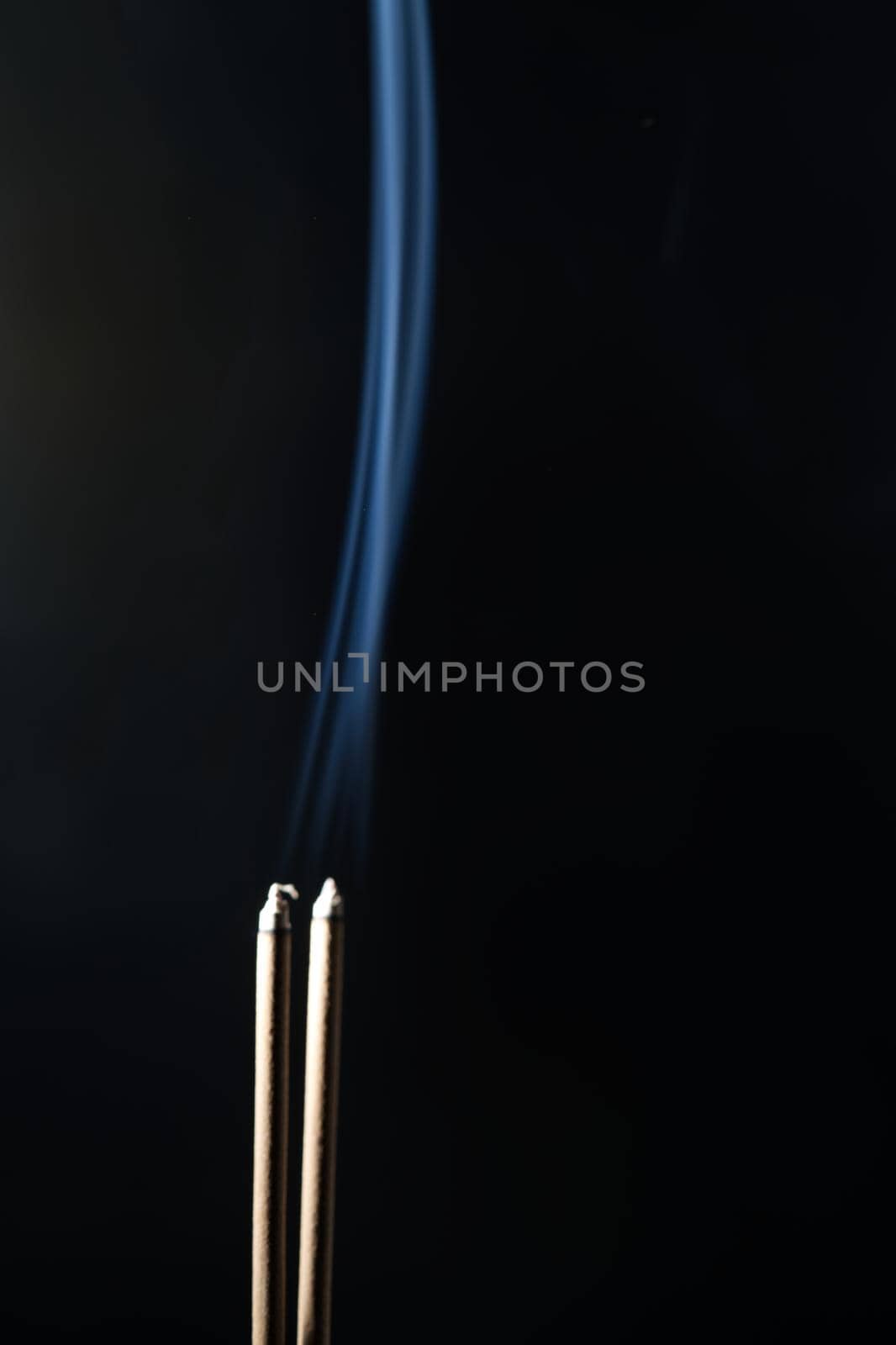 Incense burning incense, white smoke, black background, used as background image Paying homage to the sacred objects of the people of Buddhism according to their beliefs and beliefs. by noppha80