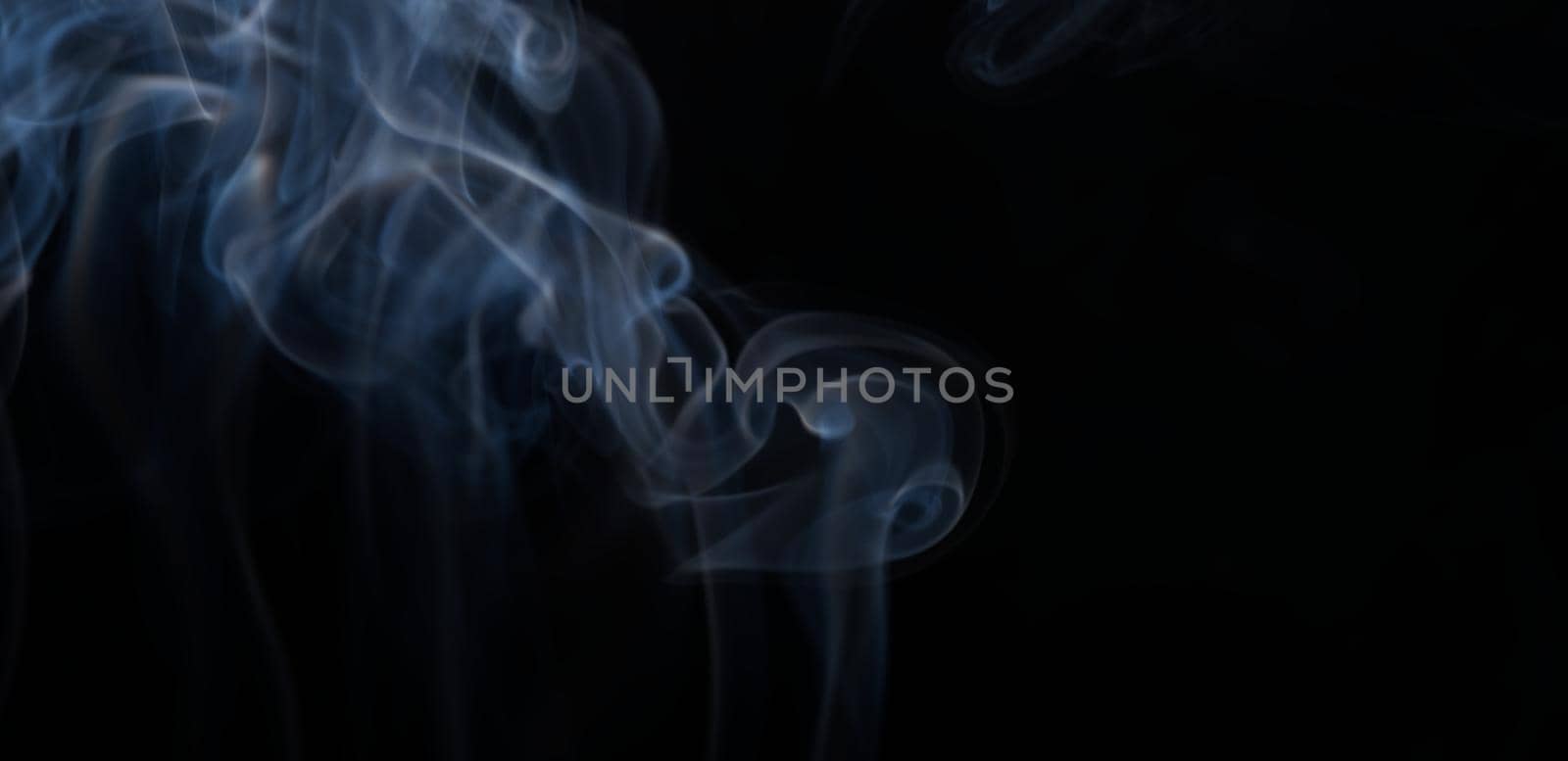 Burning incense, white smoke, black background, used as a worship background image, a sacred object of Buddhist beliefs, focus on the smoke.