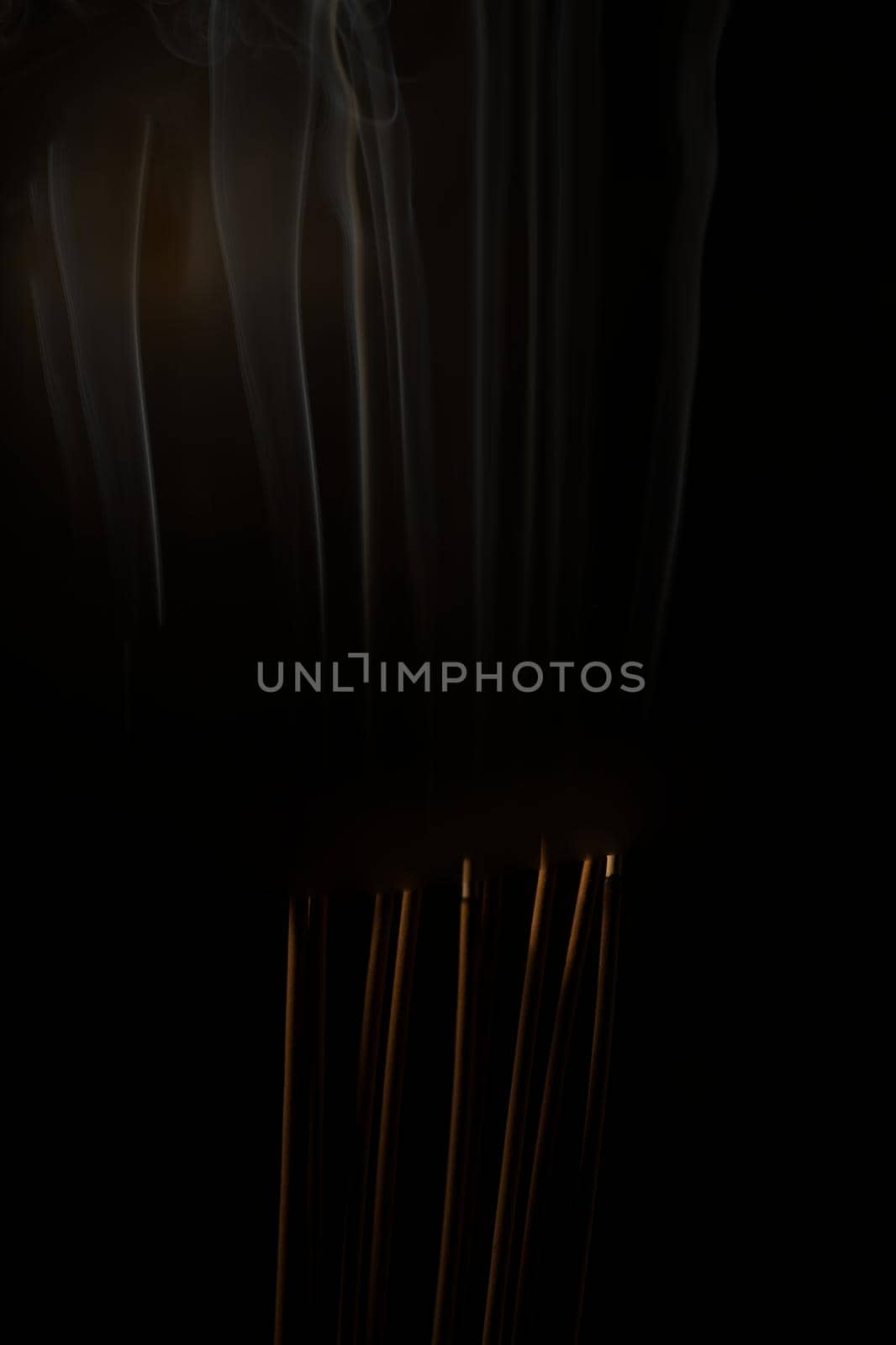 Incense burning incense, white smoke, black background, used as background image Paying homage to the sacred objects of the people of Buddhism according to their beliefs and beliefs. by noppha80