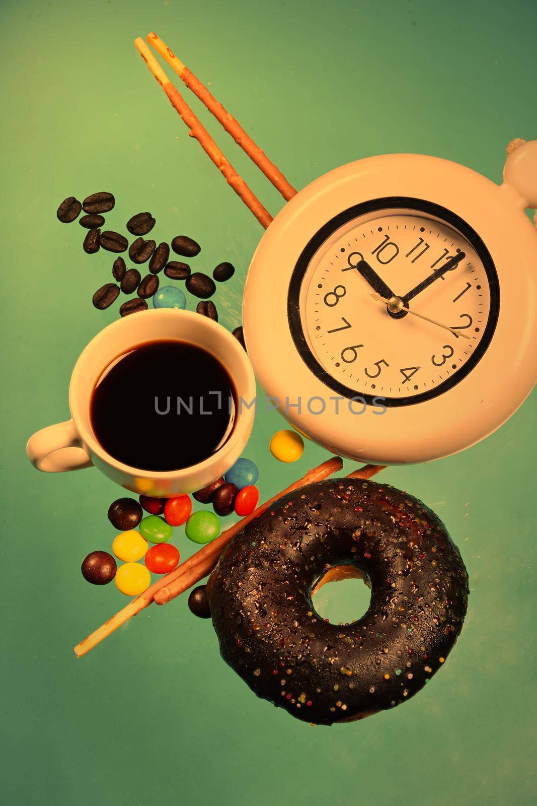 Vertical images of donuts and pastries in bright colors with a cup of hot brewed coffee. Pastel blue background concept sweets and snacks in the morning by noppha80