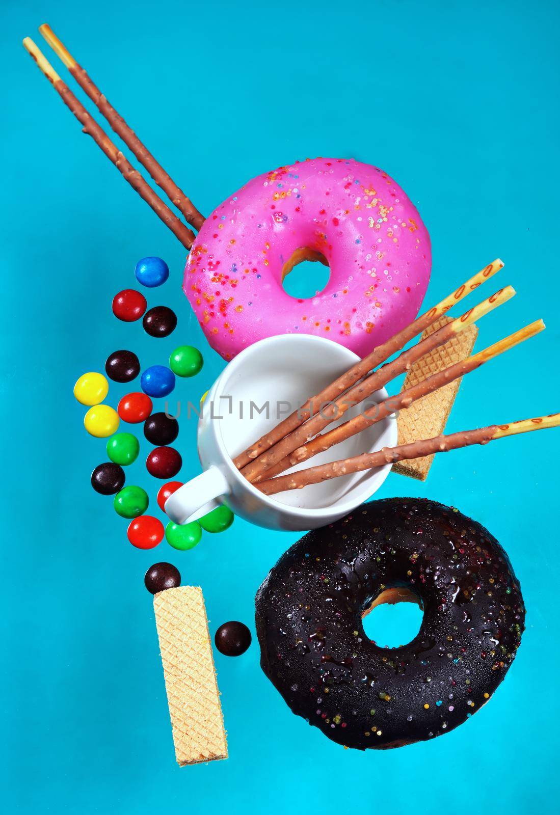 Donuts and pastries colorful background blue pastel dessert and snack concept