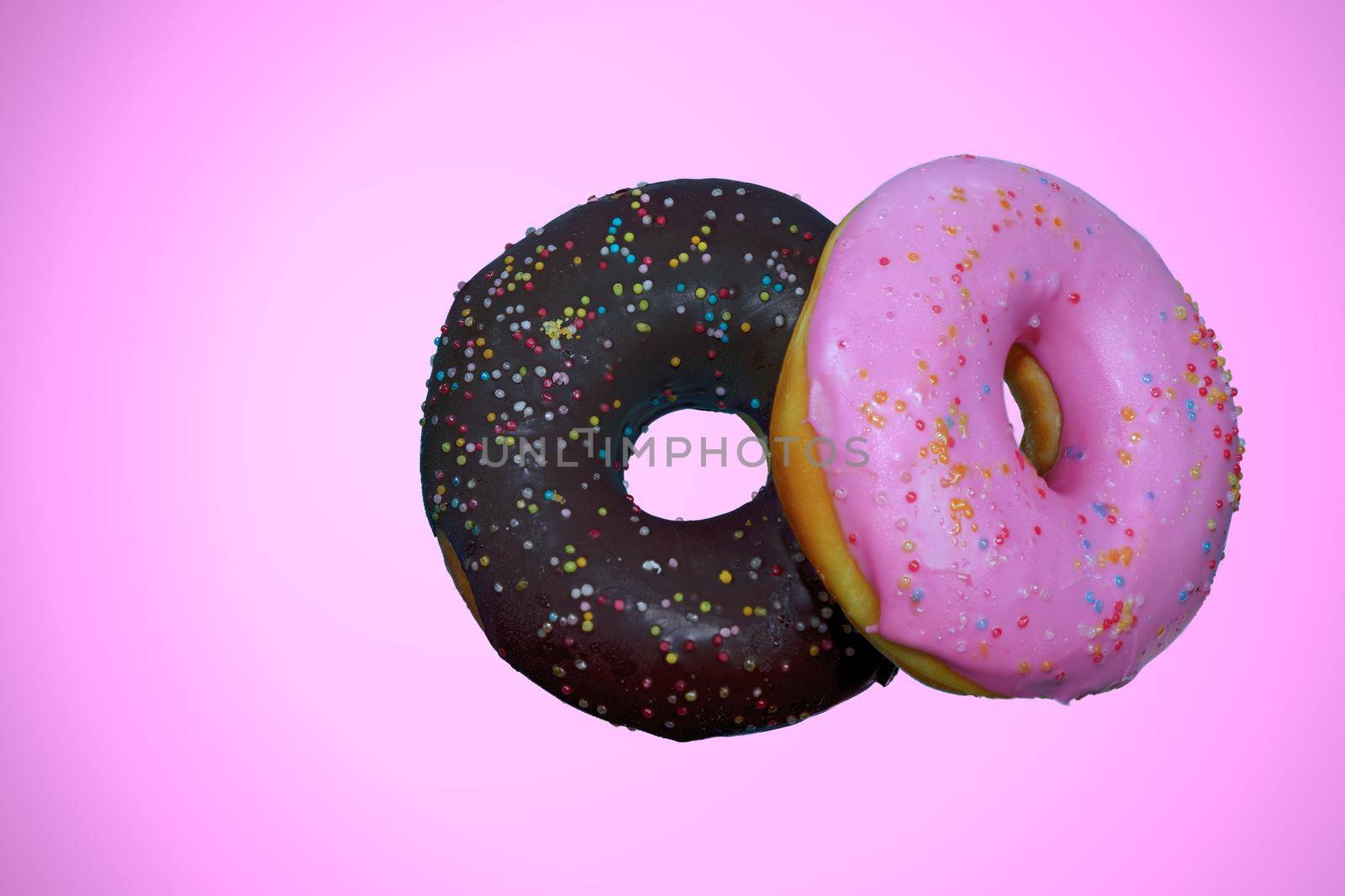 Pink Cream Donuts and Chocolate Donuts Pink background isolated.