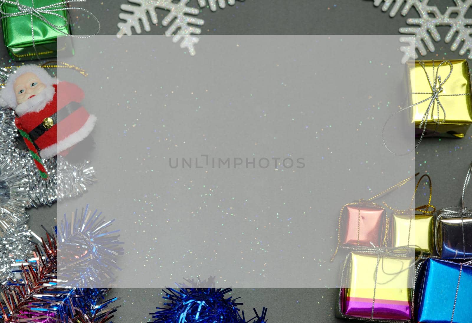 Elegant Christmas background copy space with golden snowflakes and bells with shining gift box, black wood texture background.