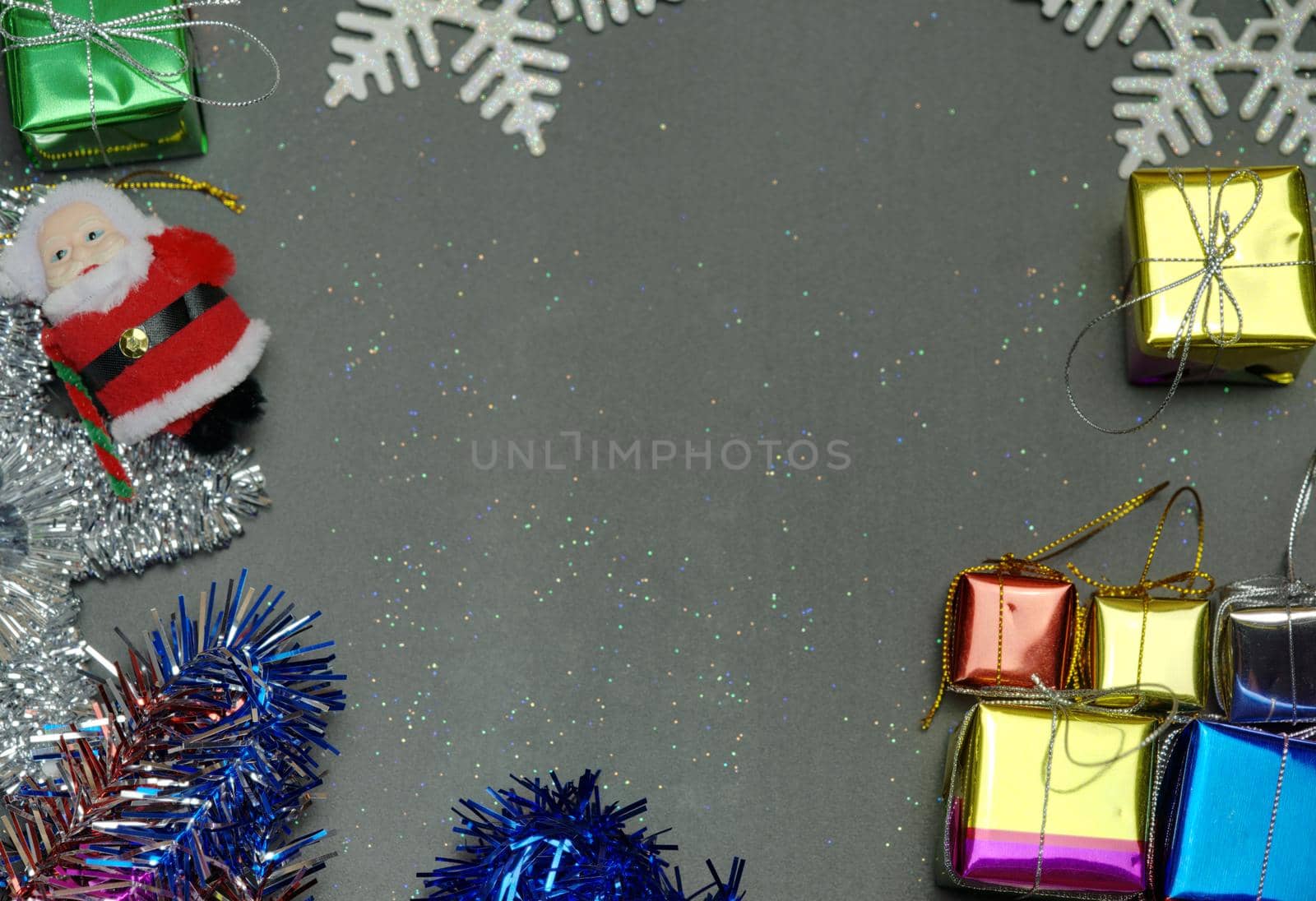 Elegant Christmas background copy space with golden snowflakes and bells with shining gift box, black wood texture background.