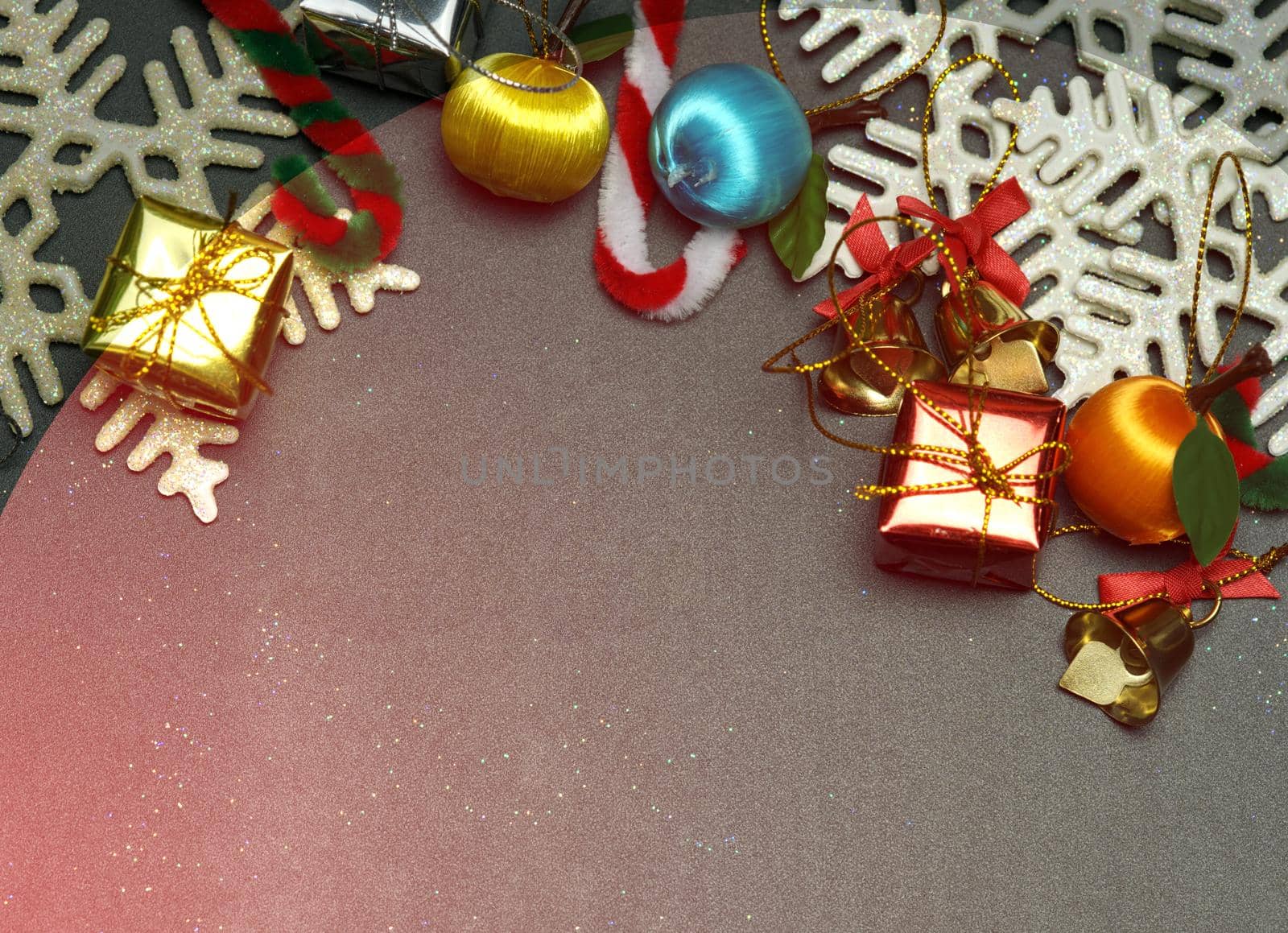 Elegant Christmas background with golden snowflakes and bells with shining gift boxes, black wood texture background.