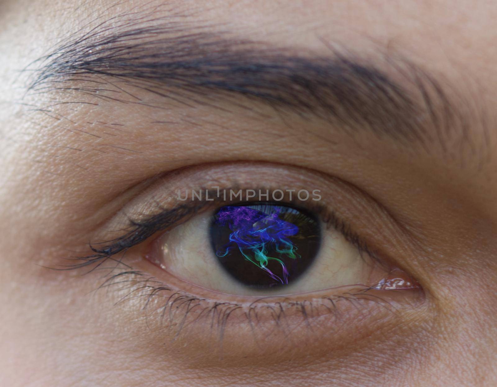 Close-up of one eye, a young Asian woman wearing Contact Fashion style Lens with beautiful eyebrows, iris treatment concept, with veins, selective focus. by noppha80