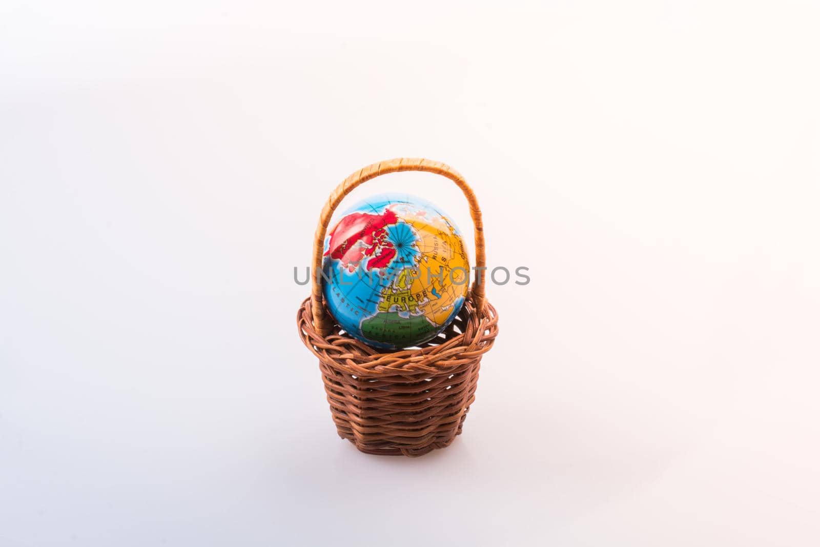 Little model globe in a basket in view