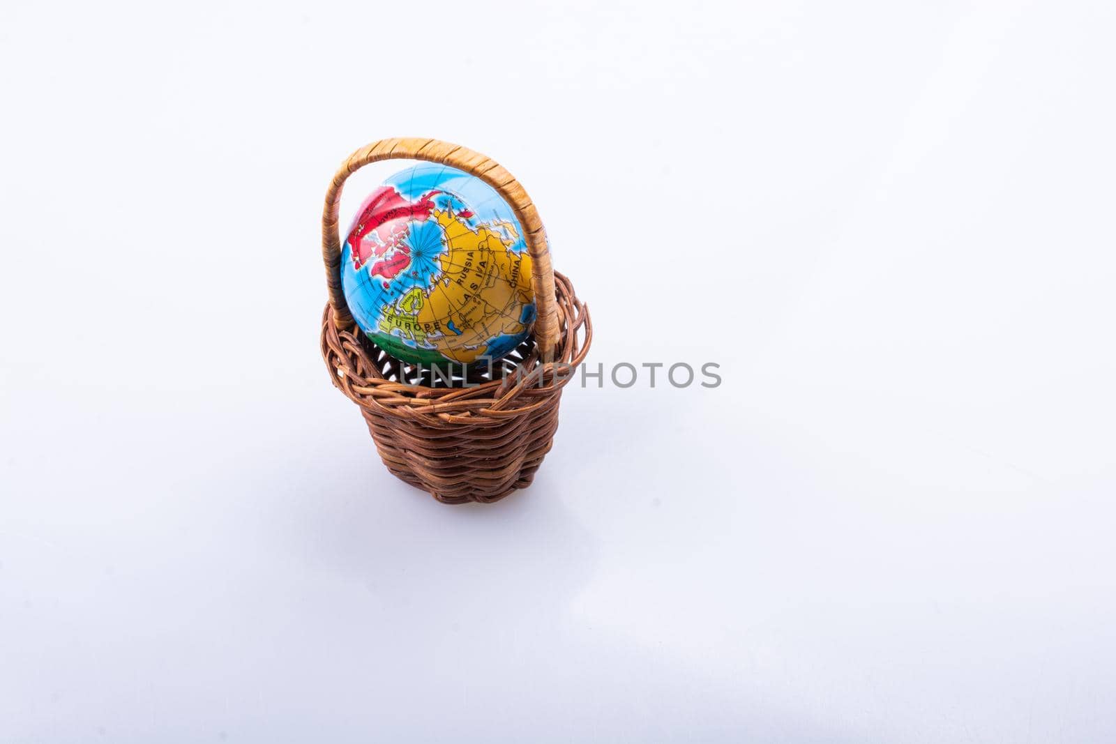 Little model globe in a basket in view