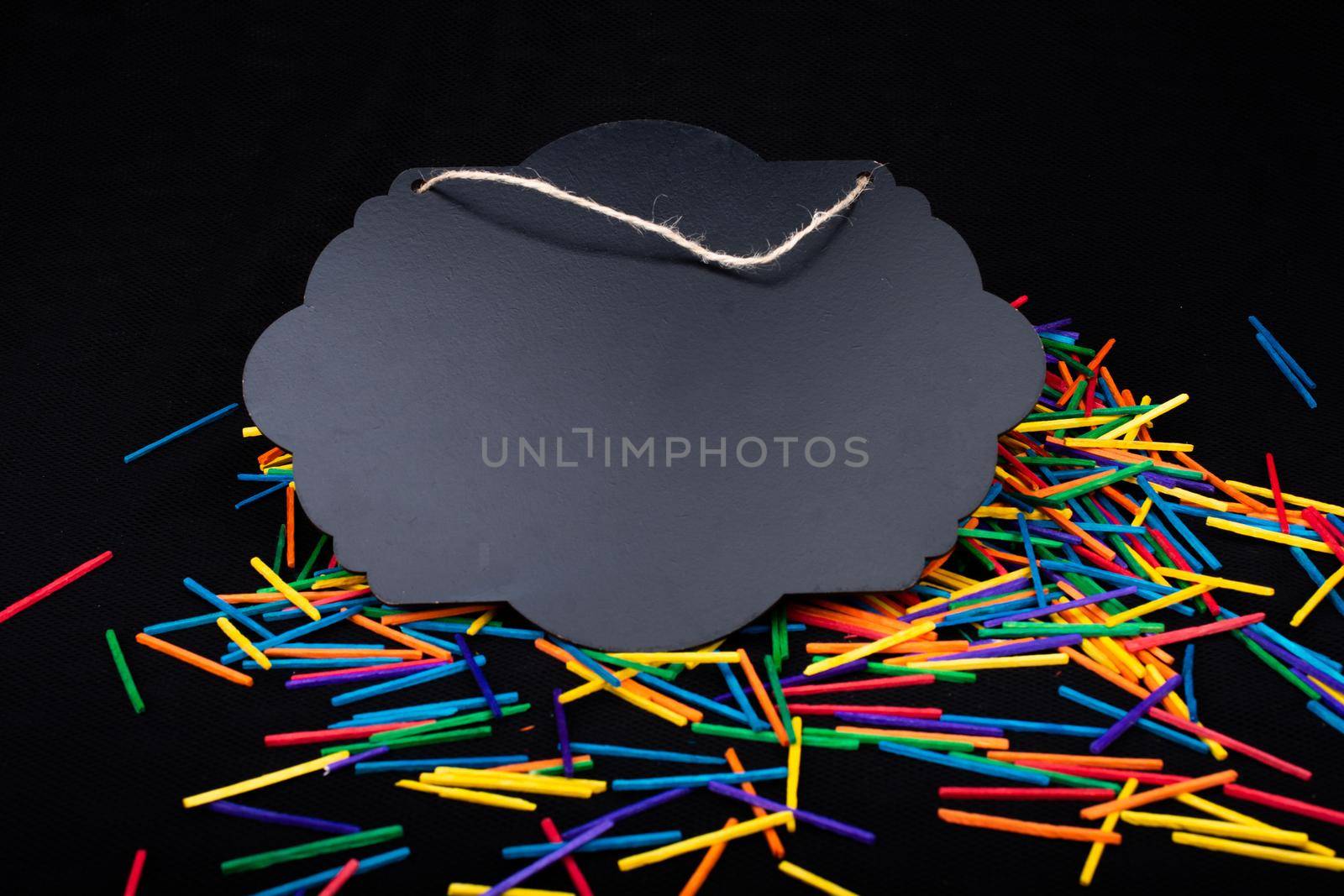 Black speech bubble shaped notice board  on colorful sticks on black