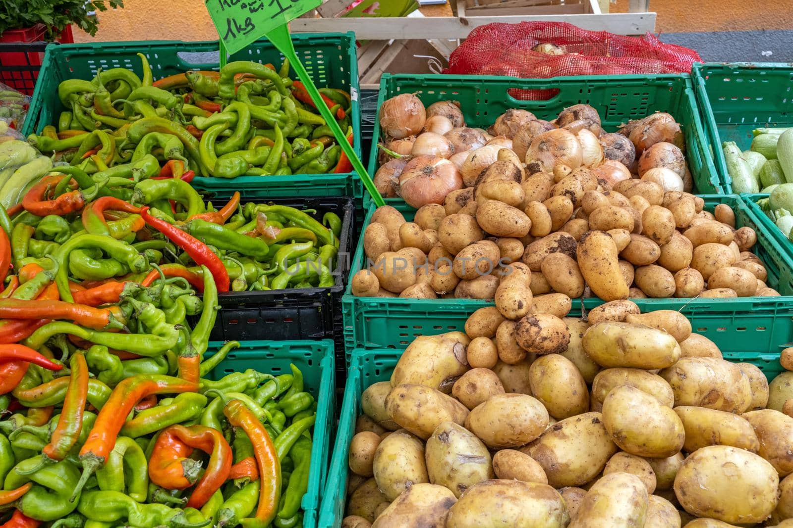 Chili peppers, potatoes and onions for sale at a market