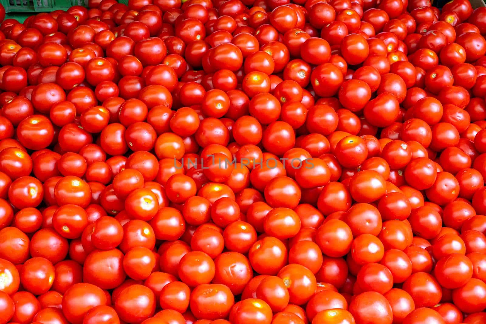 Heap of small red tomatoes for sale at a market