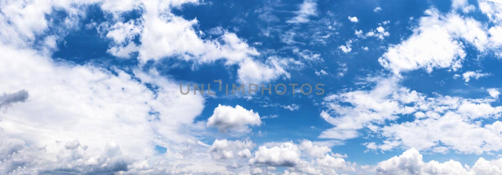 Panoramic white fluffy clouds in the blue sky, Fantastic soft white clouds against blue sky