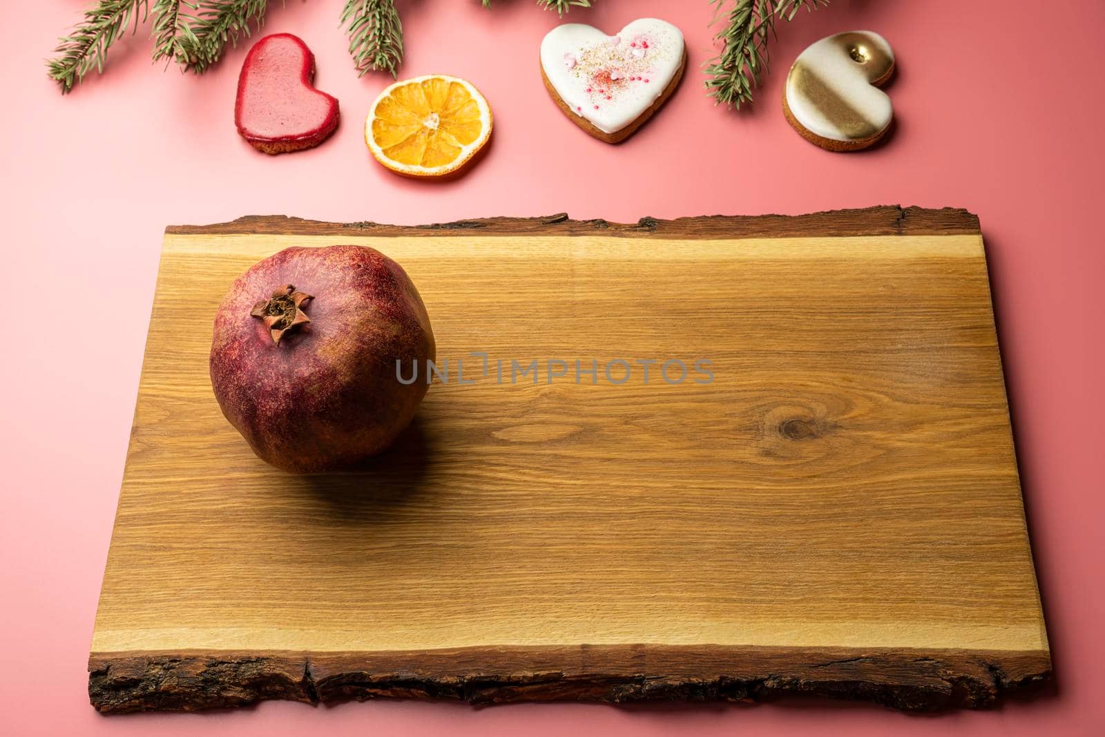 ripe pomegranate on a pink background. love. Fruit by roman112007