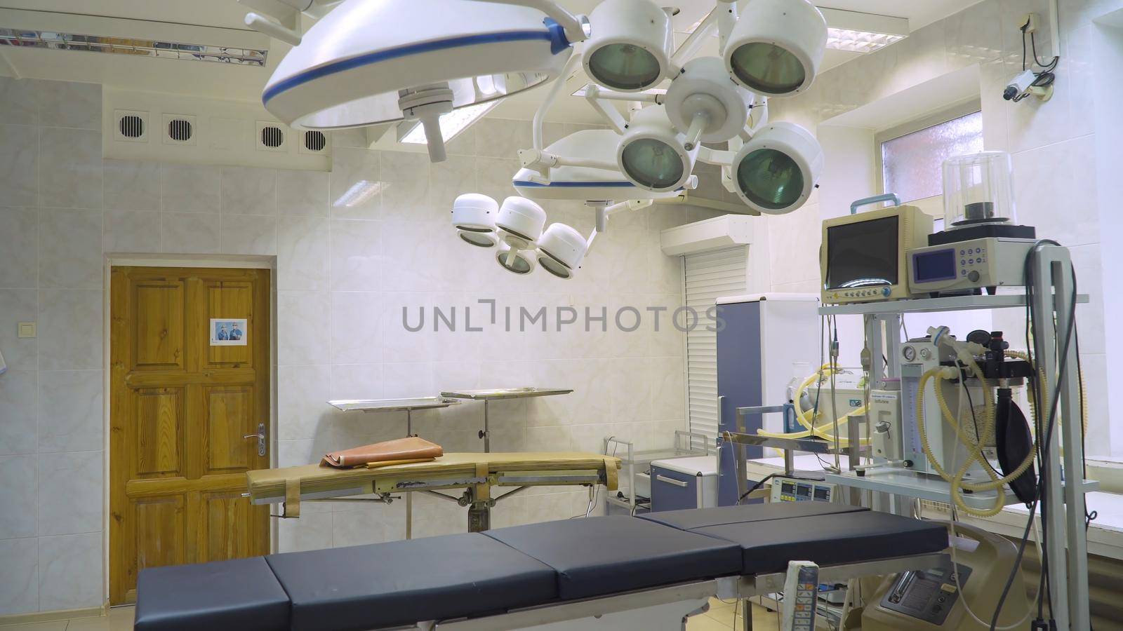 Operating room at hospital with equipment and medical devices. Table for surgical operations in the hospital. Interior of operating room in modern clinic.