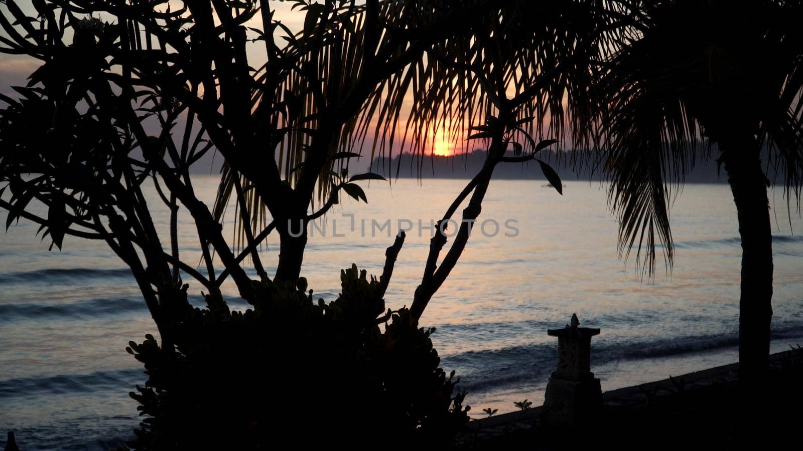 coastline with surf during sunset. sea sunset landscape on beach. Travel concept.