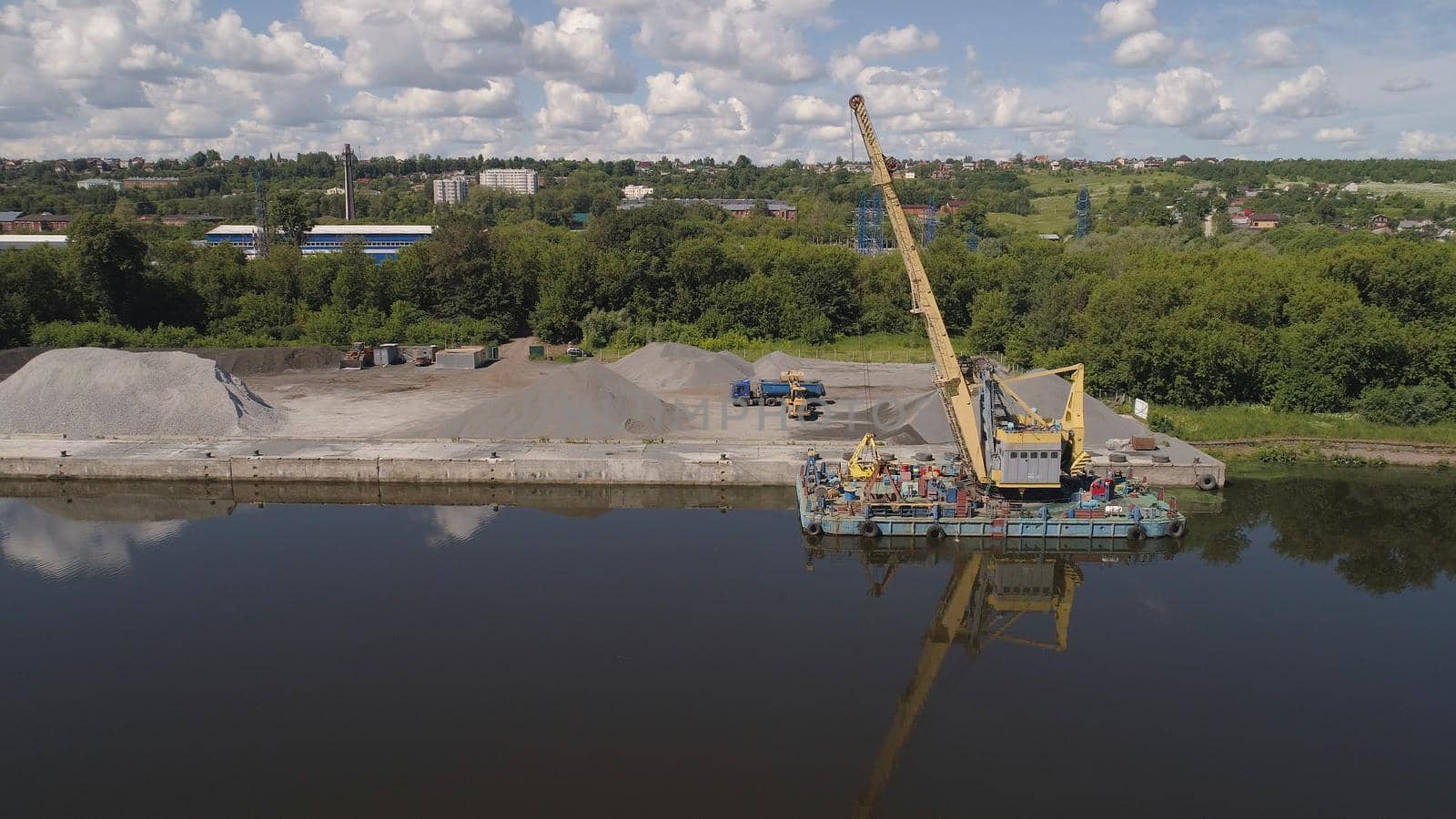 Aerial view large crane an excavator mounted on barge. Excavator on river for unloading and loading sand and rubble.