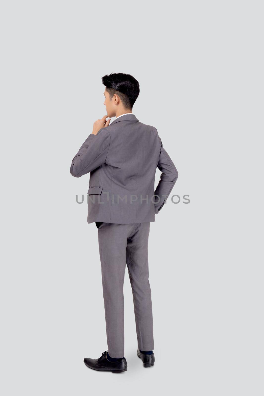 Back of young asian business man in suit standing and thinking idea for success isolated on white background, full length, rear portrait of handsome businessman, question and planning decide.